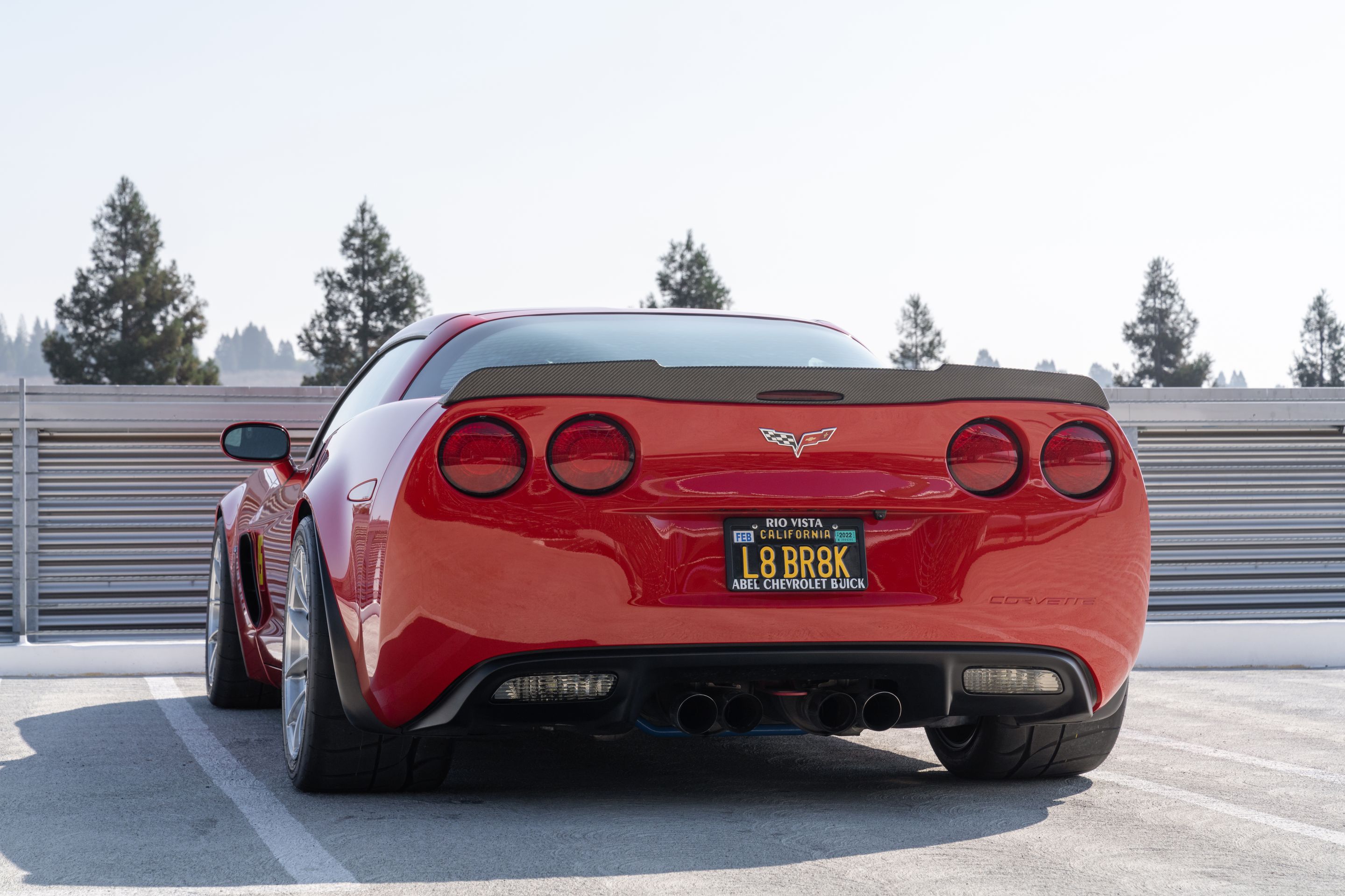 Red Chevrolet C6 Corvette Z06 with 18" VS-5RS Apex wheels in Brushed Clear