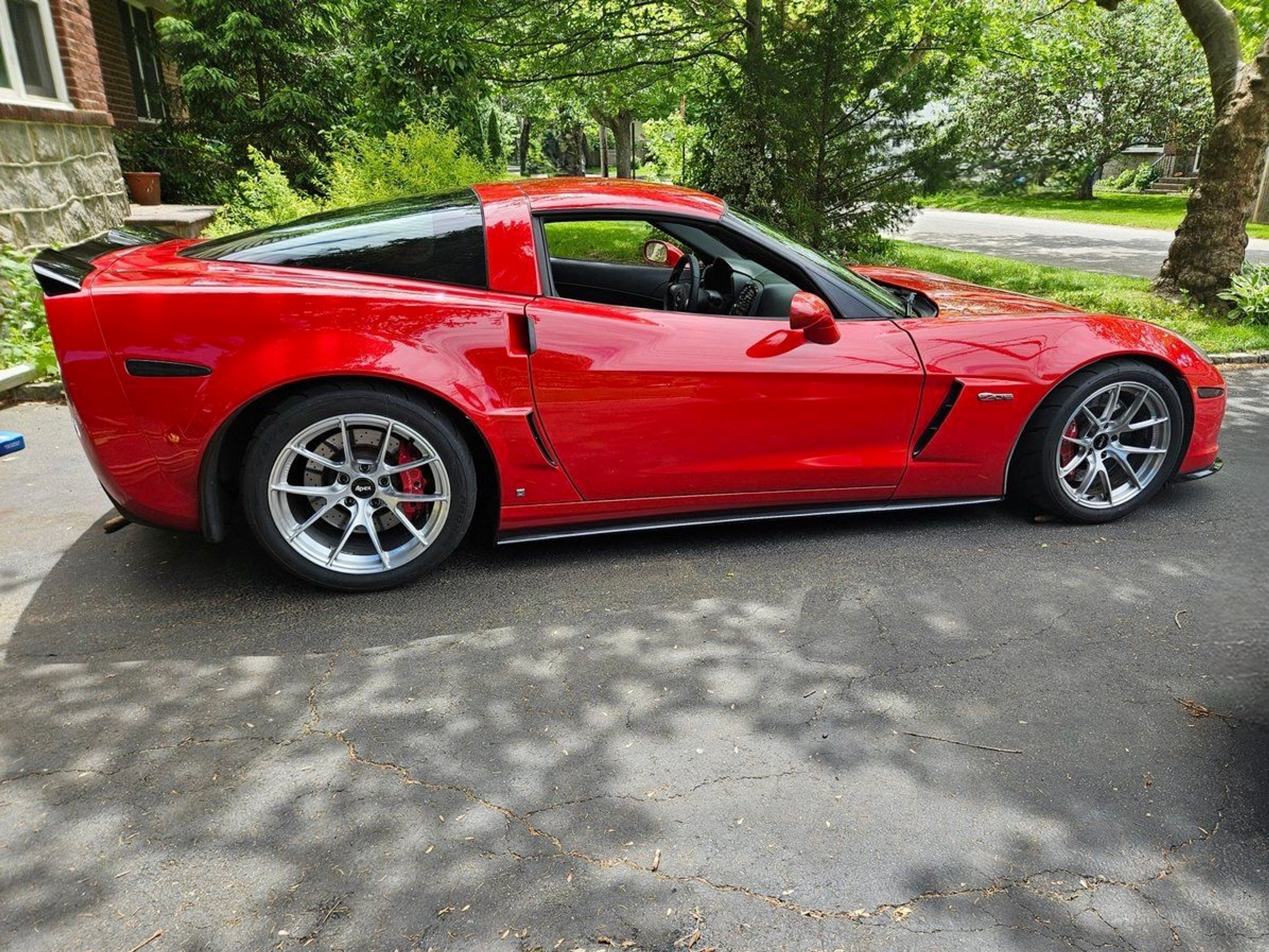 Red Chevrolet C6 Corvette Z06 with 18" VS-5RS Apex wheels in Brushed Clear