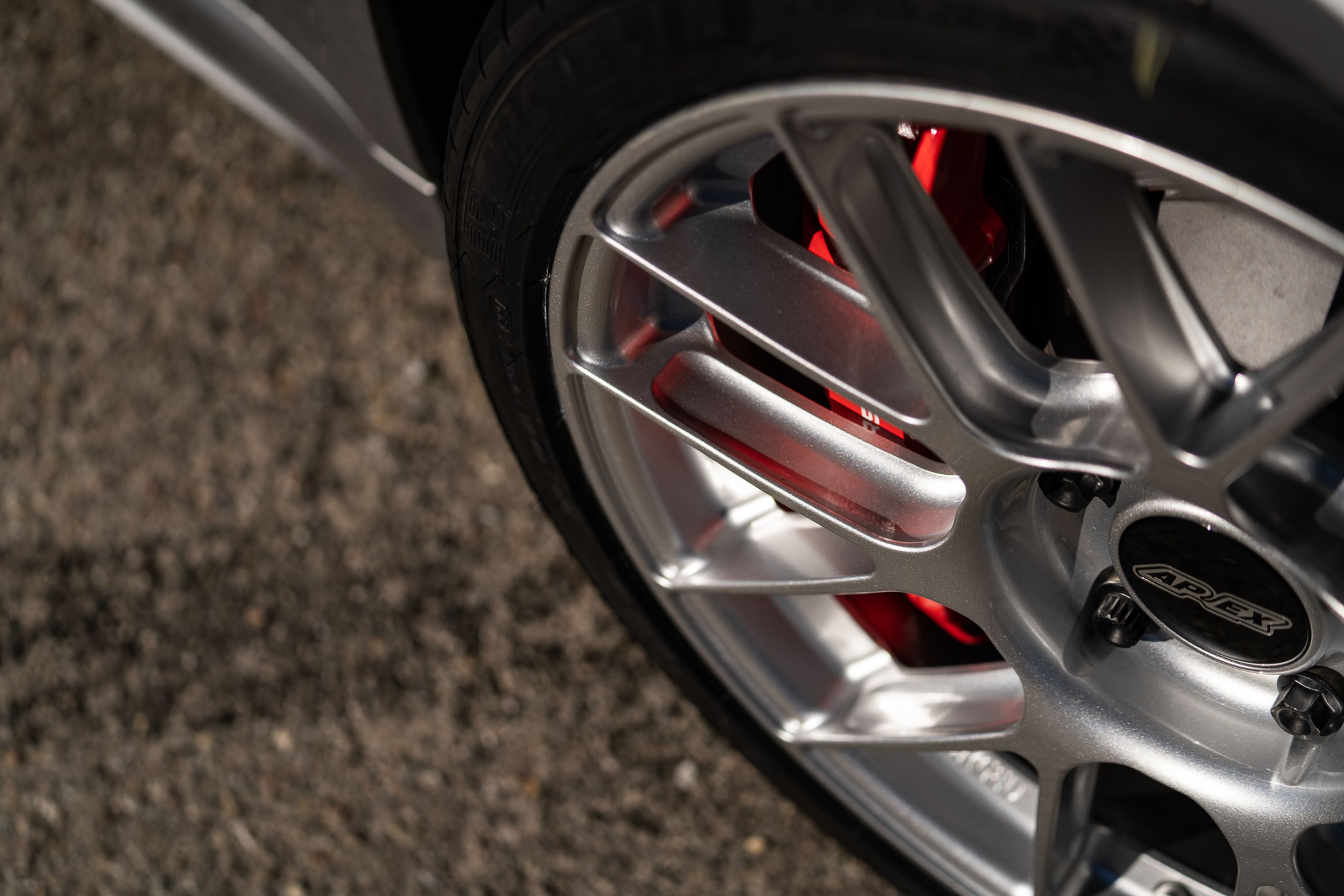 Grey Porsche 718 Cayman GT4 with 19" EC-7RS Apex wheels in Race Silver