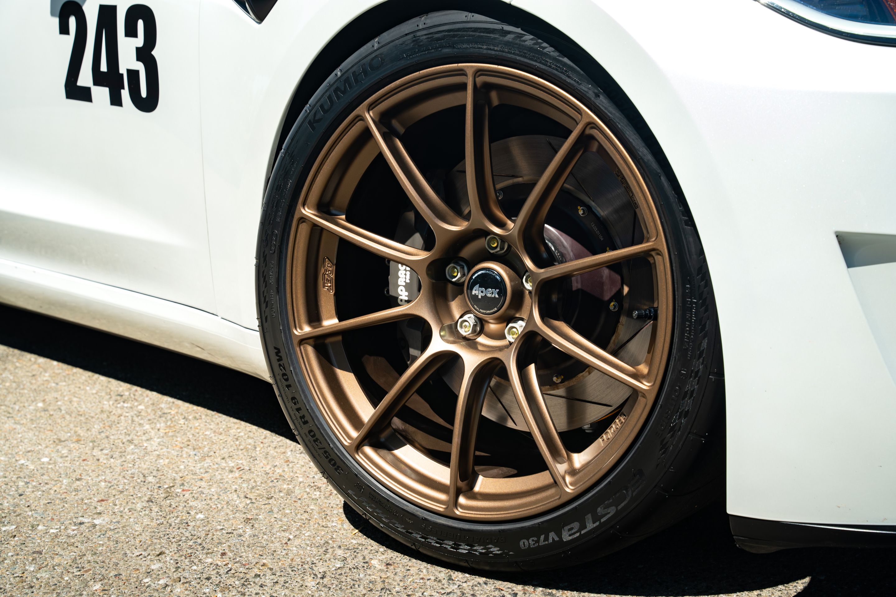 White Tesla Model 3 with 19" SM-10RS Apex wheels in Satin Bronze