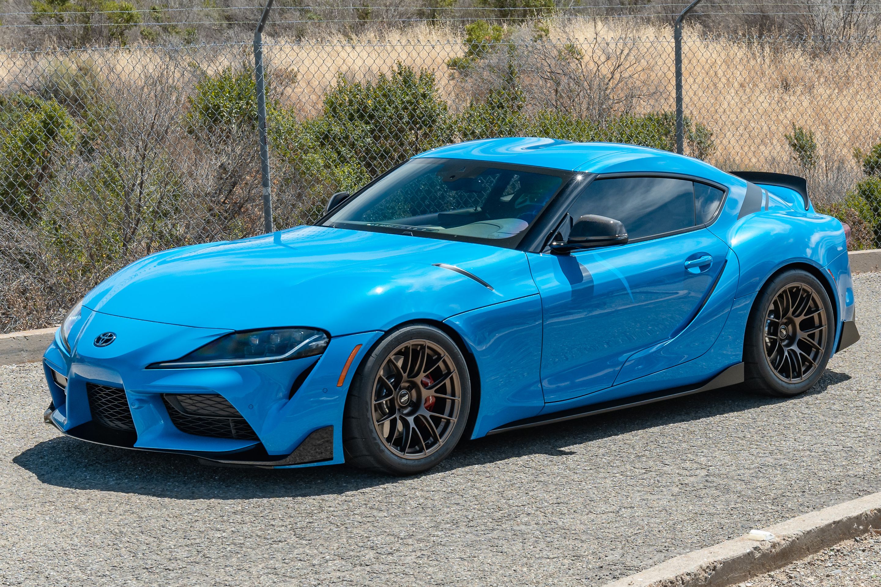 Blue Toyota GR Supra with 18" EC-7RS Apex wheels in Satin Bronze
