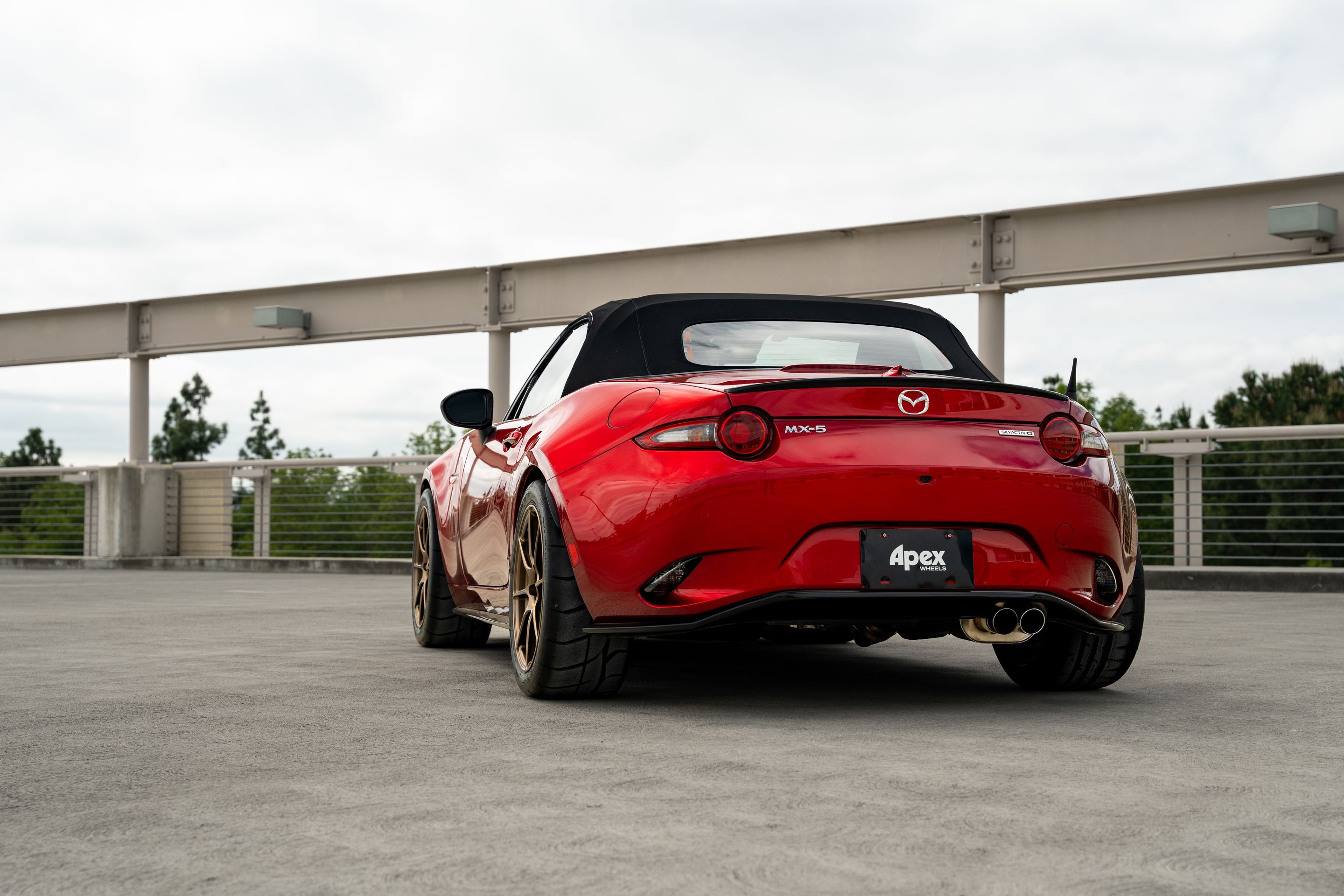Red Mazda ND MX-5 Miata with 17" SM-8RS Apex wheels in Satin Bronze