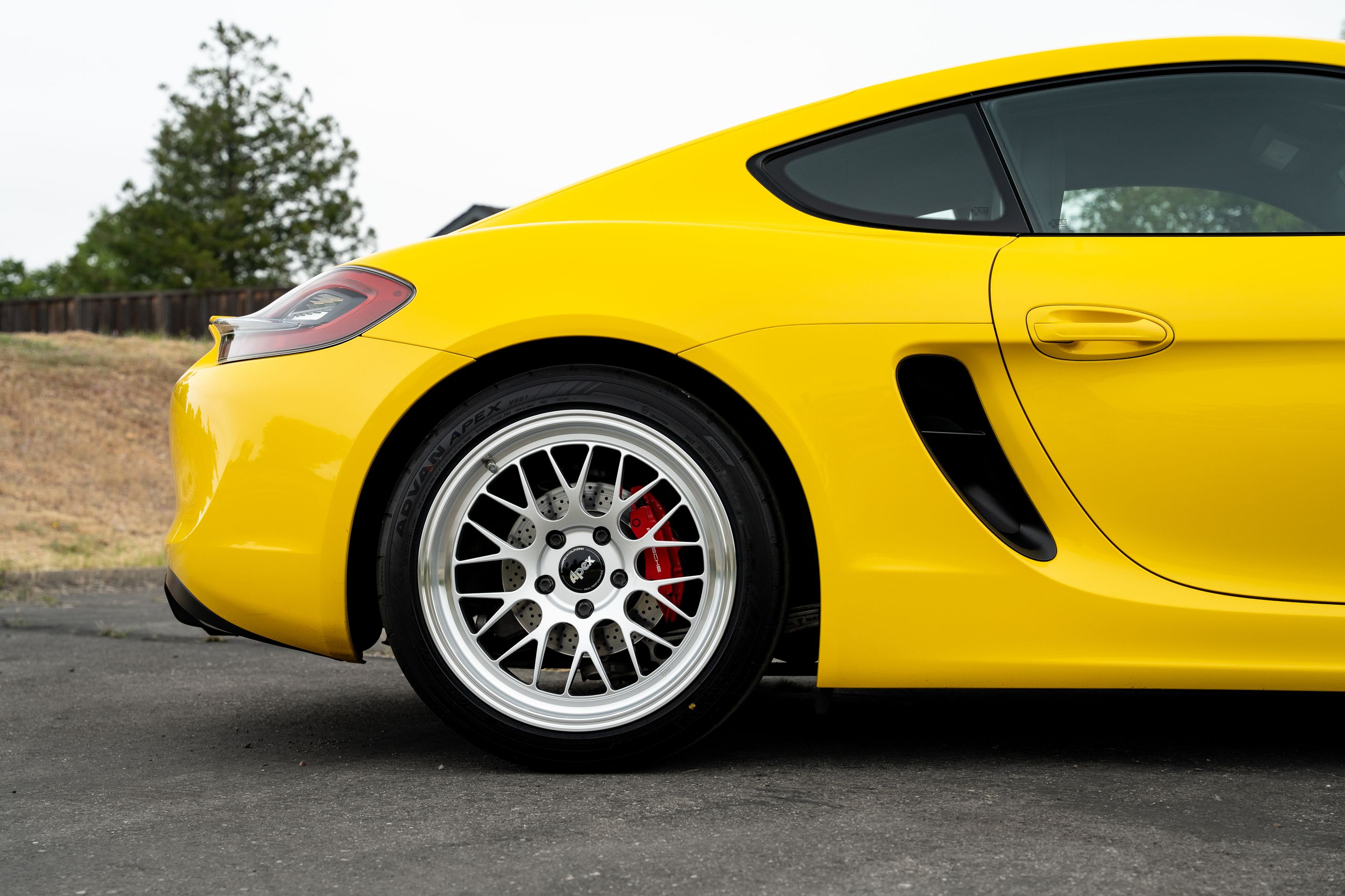 Yellow Porsche 981 Cayman GTS with 19" ML-10RT Apex wheels in Machined Lip Race Silver