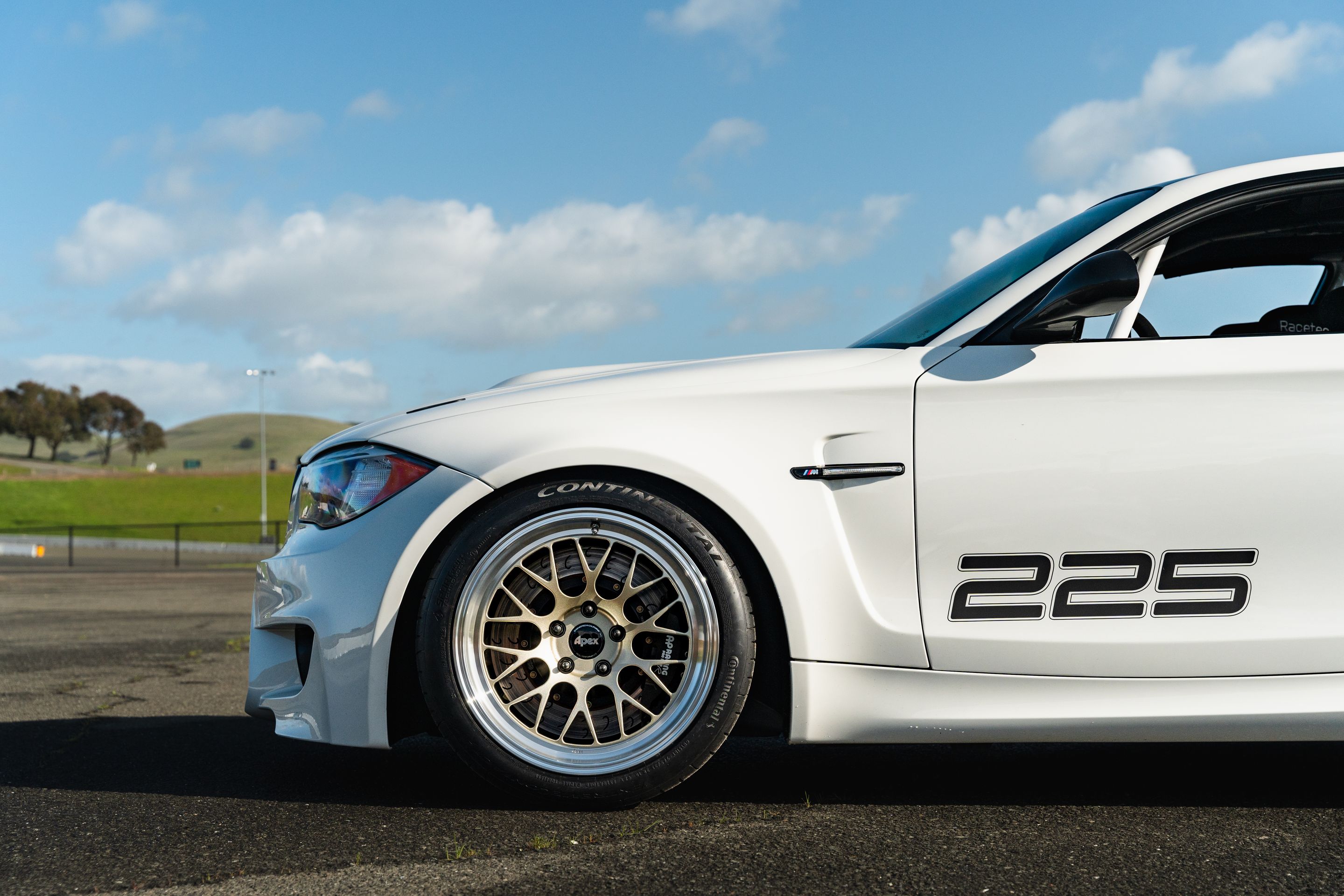 White BMW E82 1M with 18" ML-10RT Apex wheels in Machined Lip Gloss Motorsport Gold