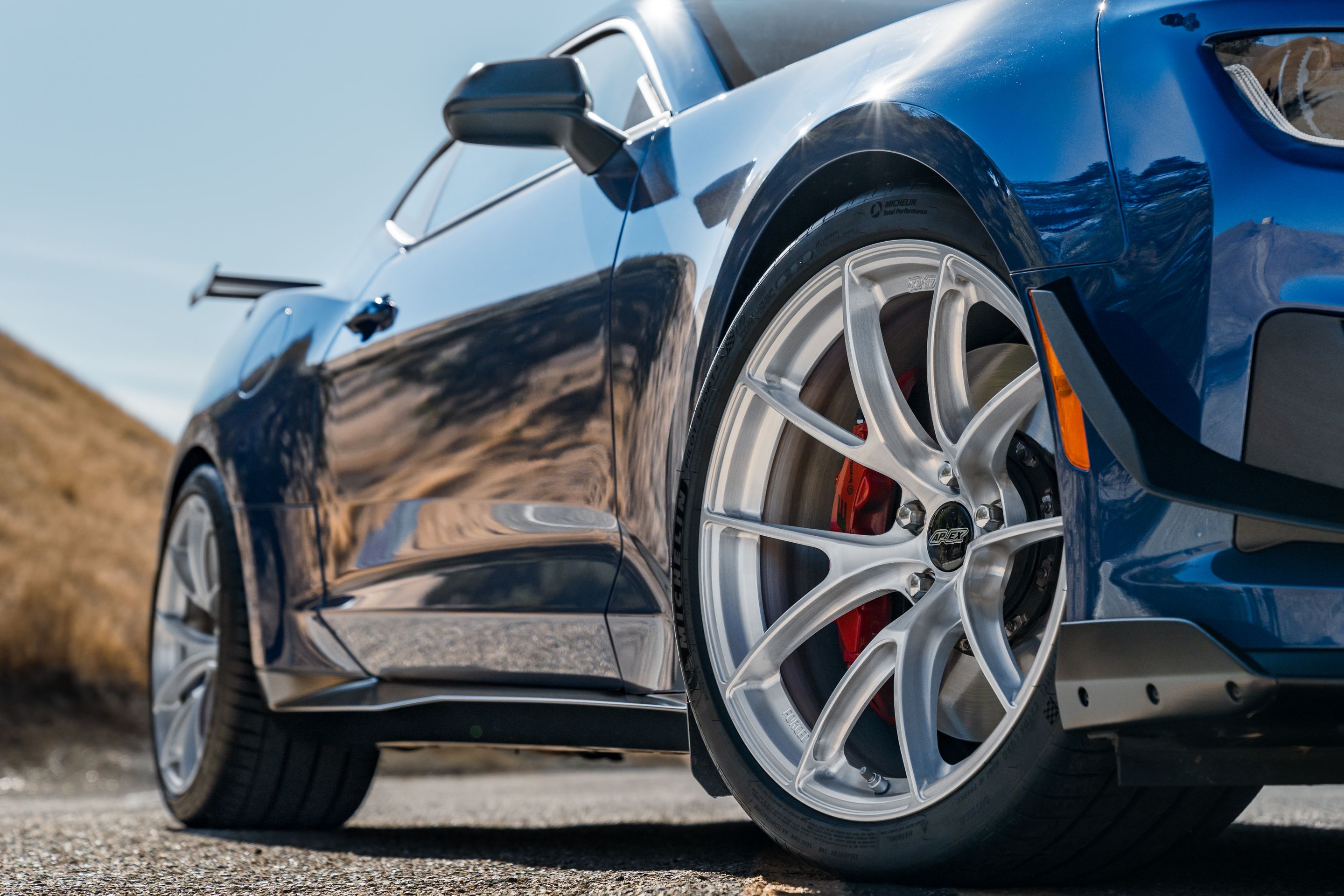 Blue Chevrolet 6th Gen Camaro ZL1 1LE with 20" VS-5RS Apex wheels in Brushed Clear