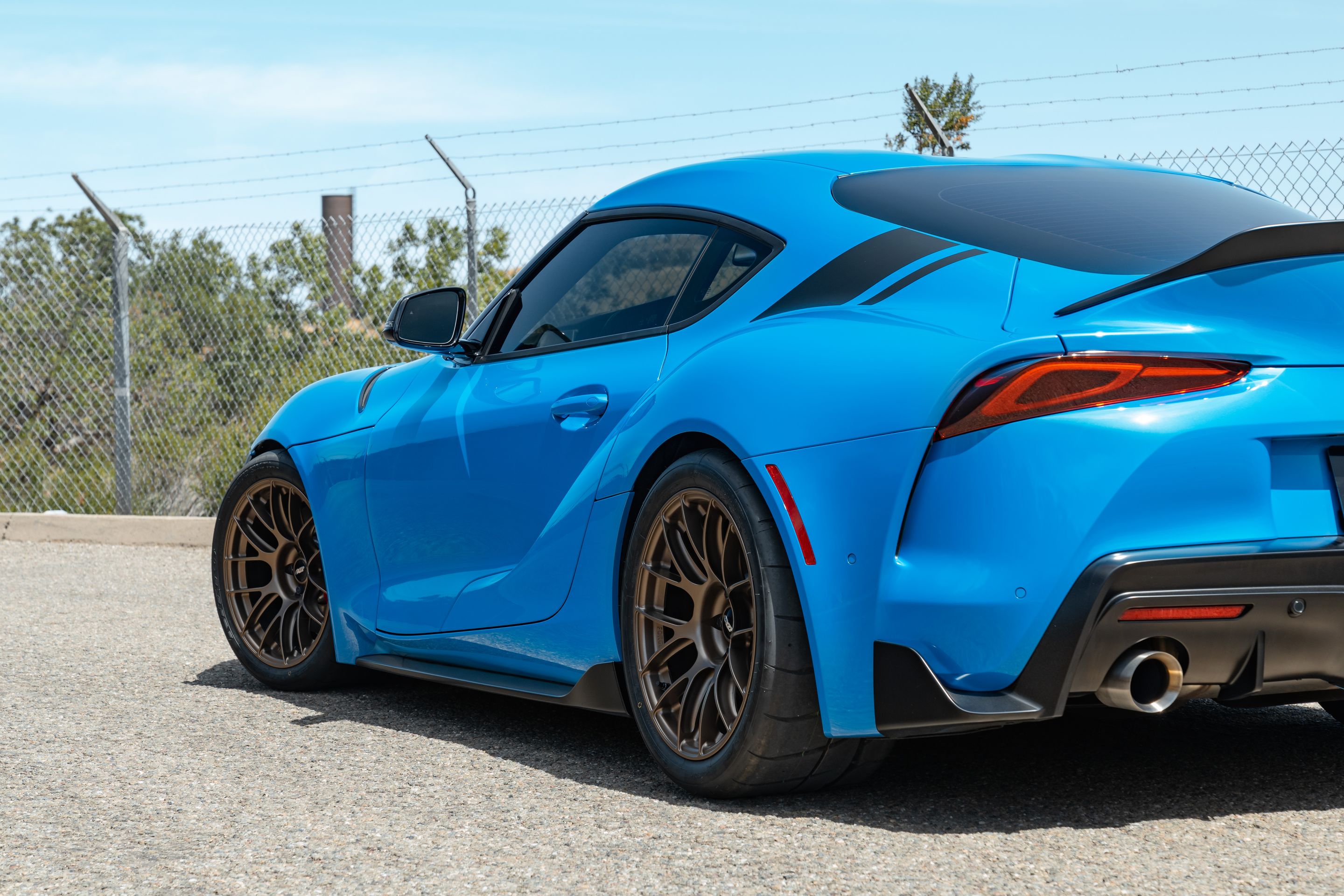 Blue Toyota GR Supra with 18" EC-7RS Apex wheels in Satin Bronze