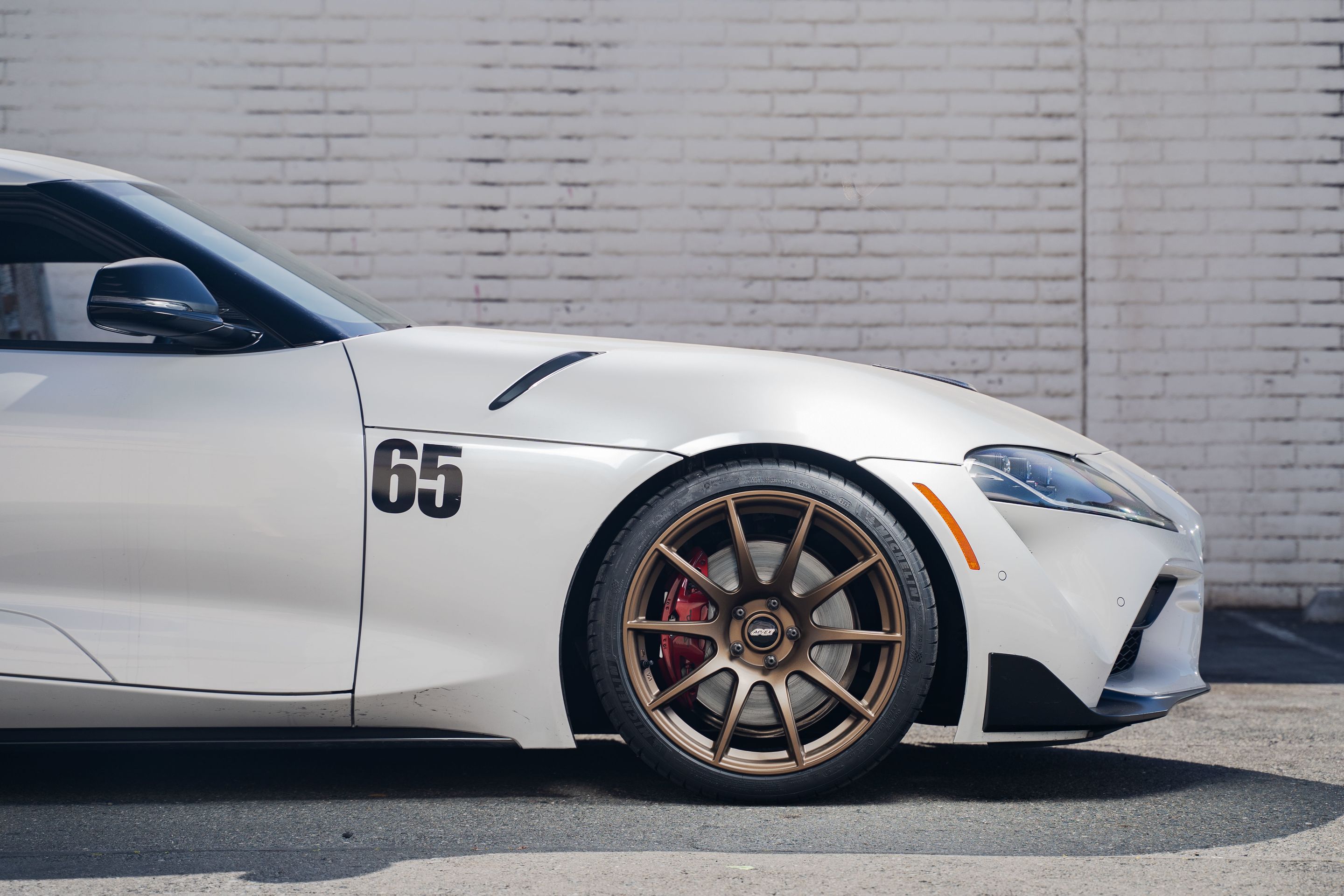 White Toyota GR Supra with 19" SM-10 Apex wheels in Satin Bronze