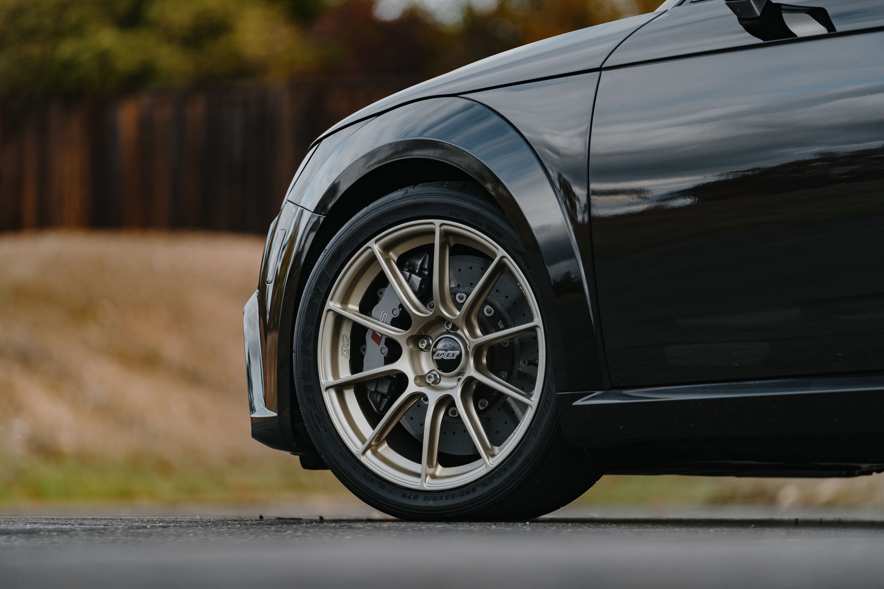 Black Audi FV/8S TT RS with 18" SM-10RS Apex wheels in Motorsport Gold