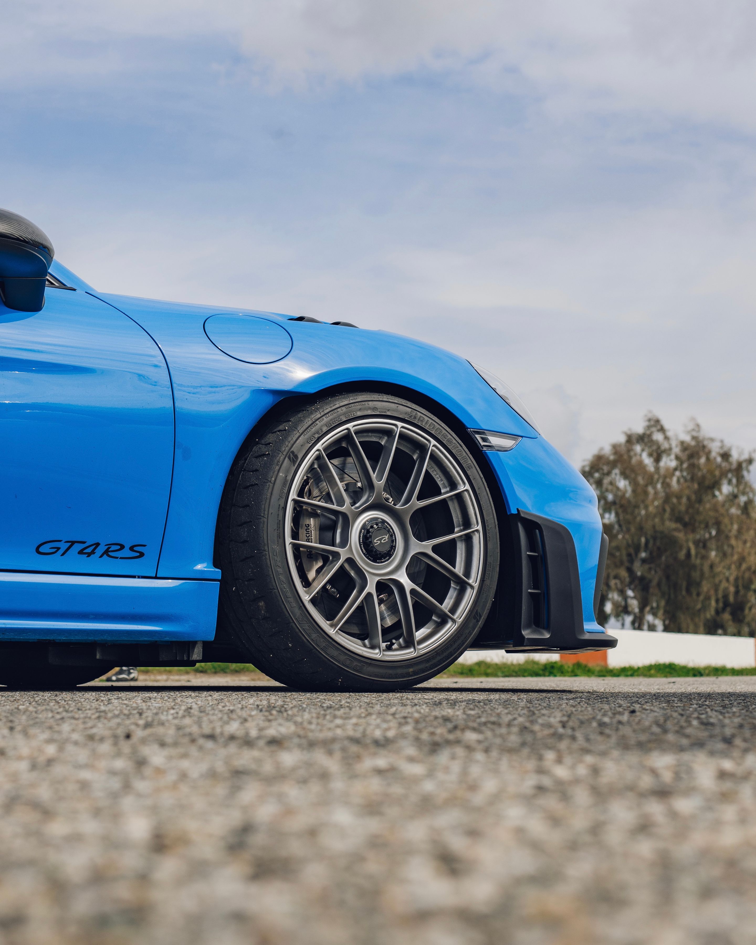 Blue Porsche 718 Cayman GT4 RS with 19" EC-7RS Apex wheels in Race Silver