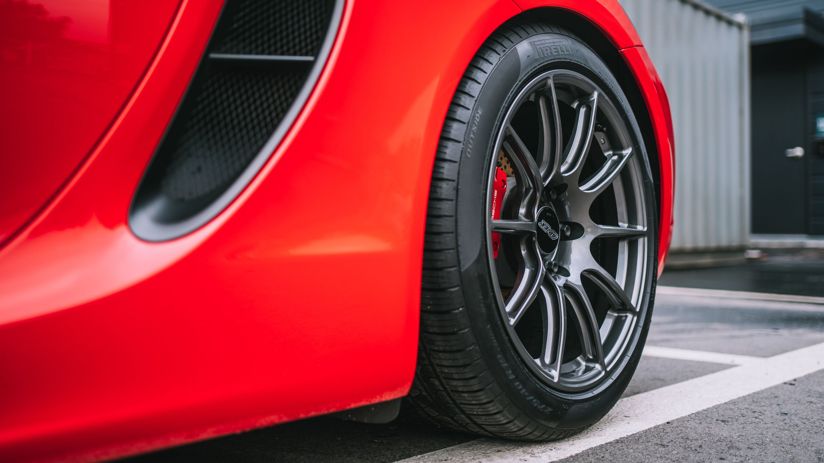 Red Porsche 981 Cayman S with 19" SM-10 Apex wheels in Anthracite