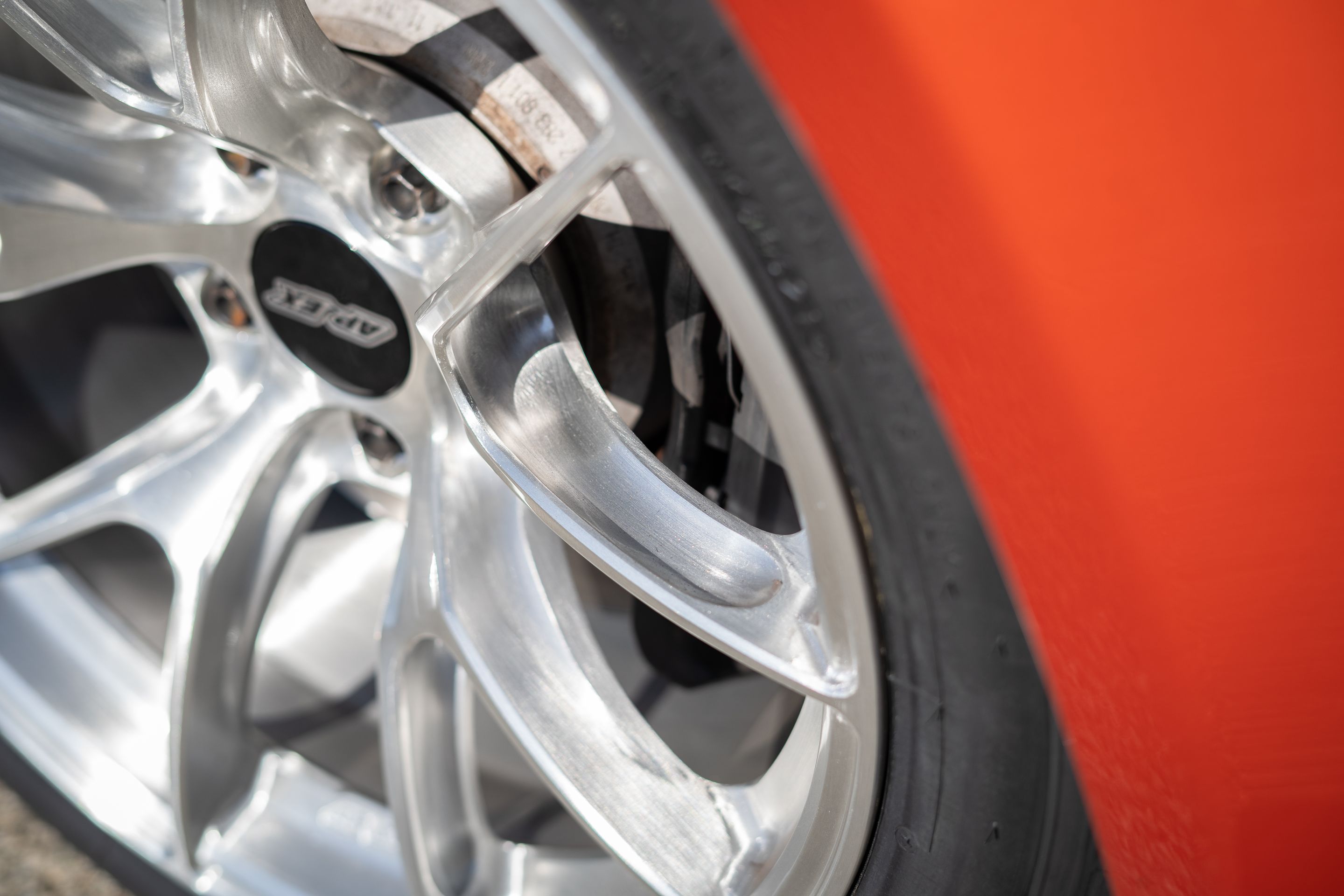 Orange BMW E82 1M with 18" VS-5RS Apex wheels in Brushed Clear