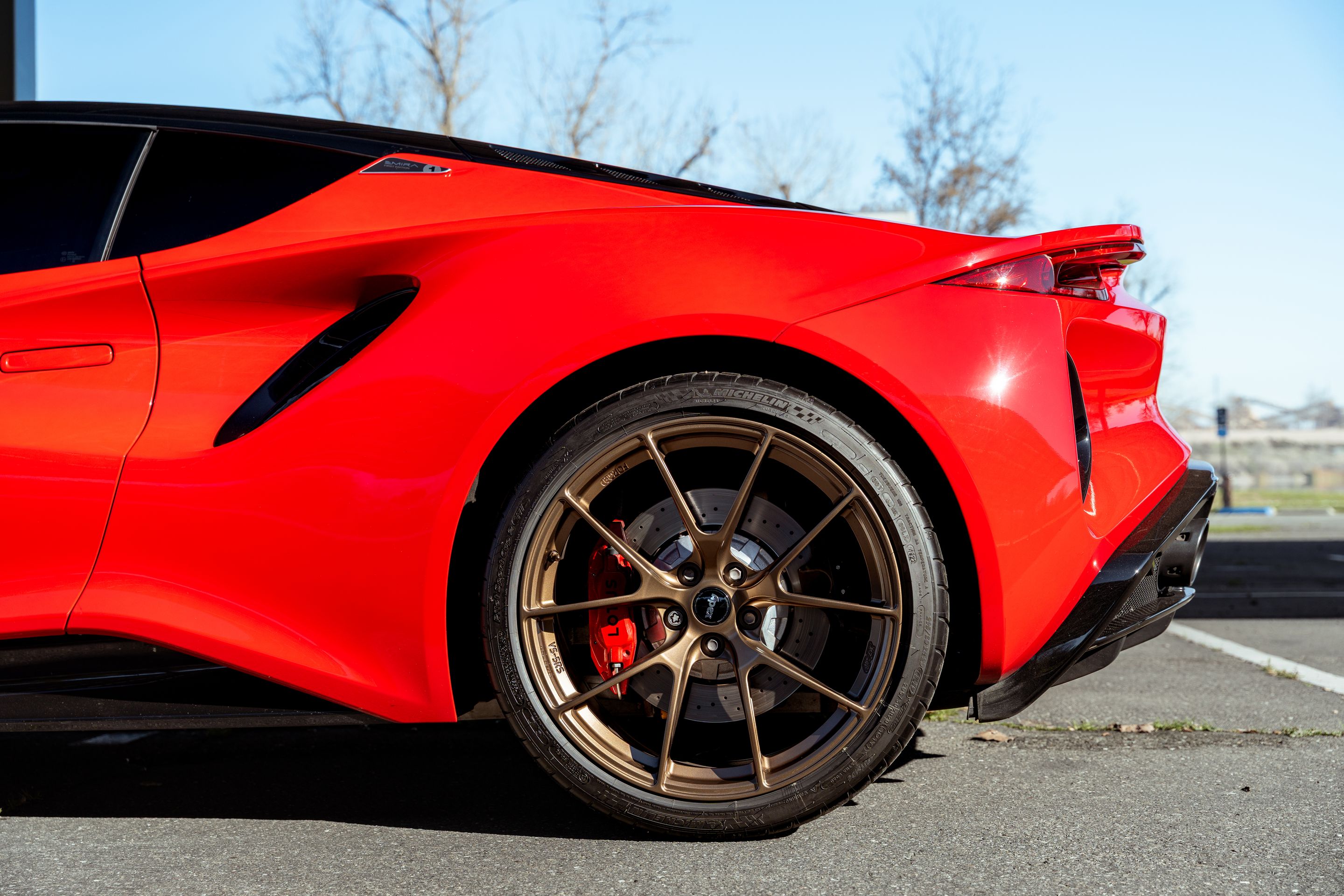 Red Lotus Emira with 20" VS-5RS Apex wheels in Anthracite