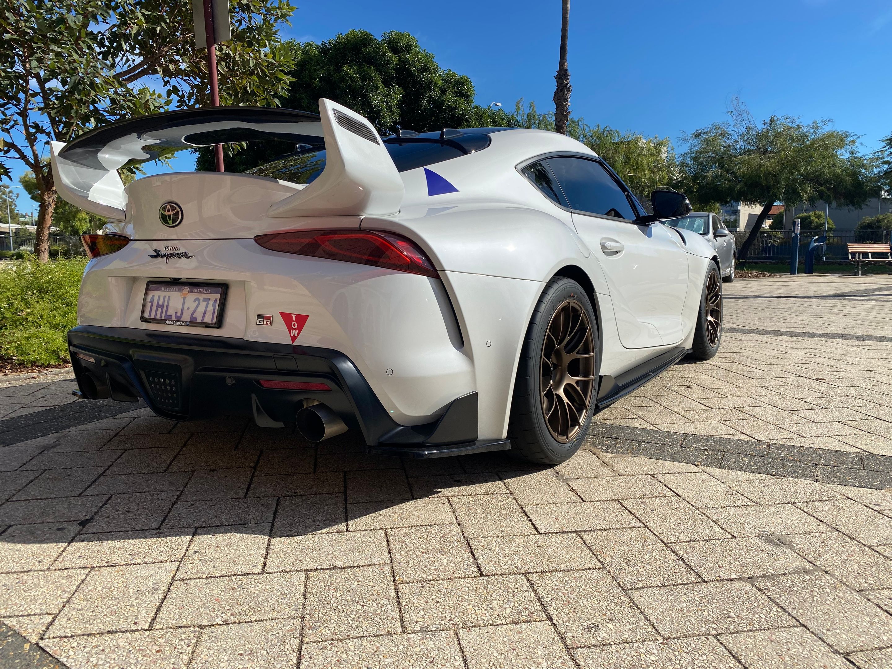 White Toyota GR Supra with 18" EC-7RS Apex wheels in Satin Bronze