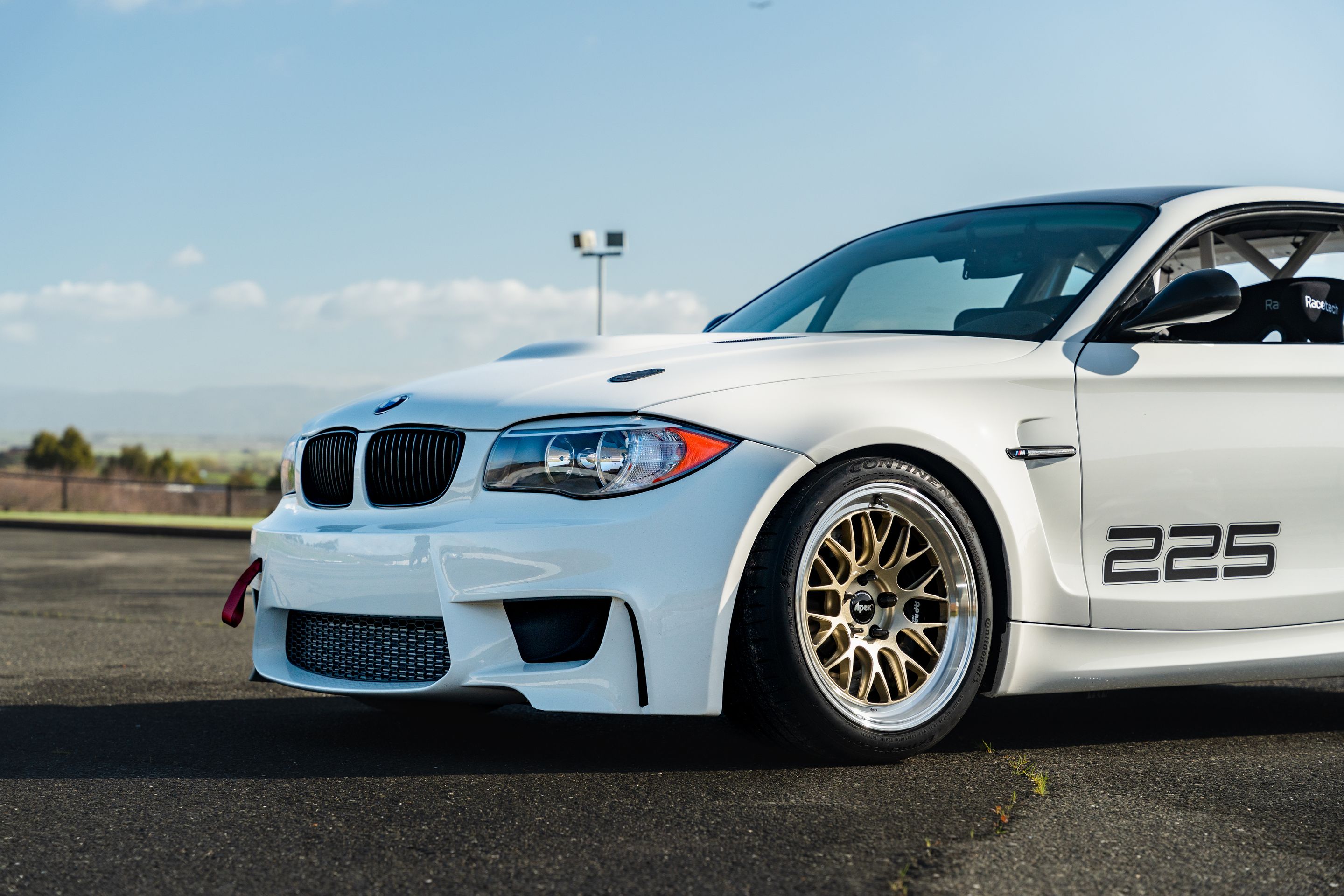 White BMW E82 1M with 18" ML-10RT Apex wheels in Machined Lip Gloss Motorsport Gold