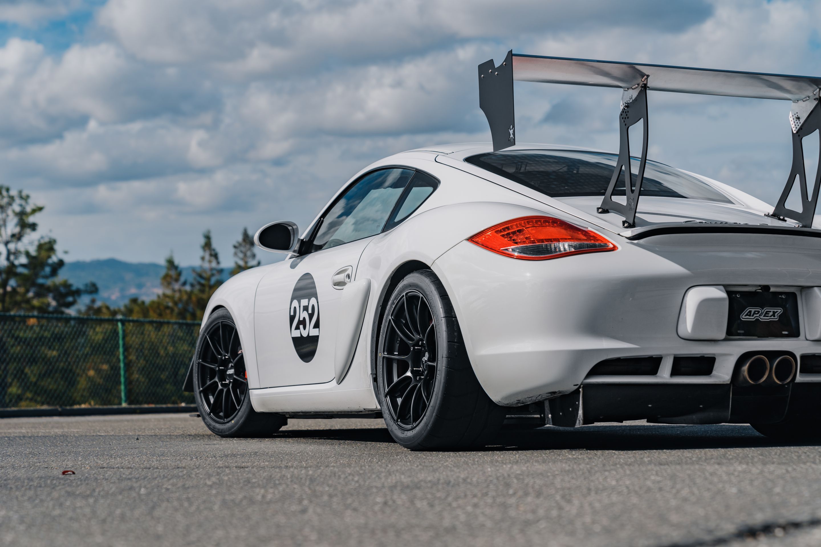 White Porsche 987 Cayman S with 18" SM-10RS Apex wheels in Satin Black