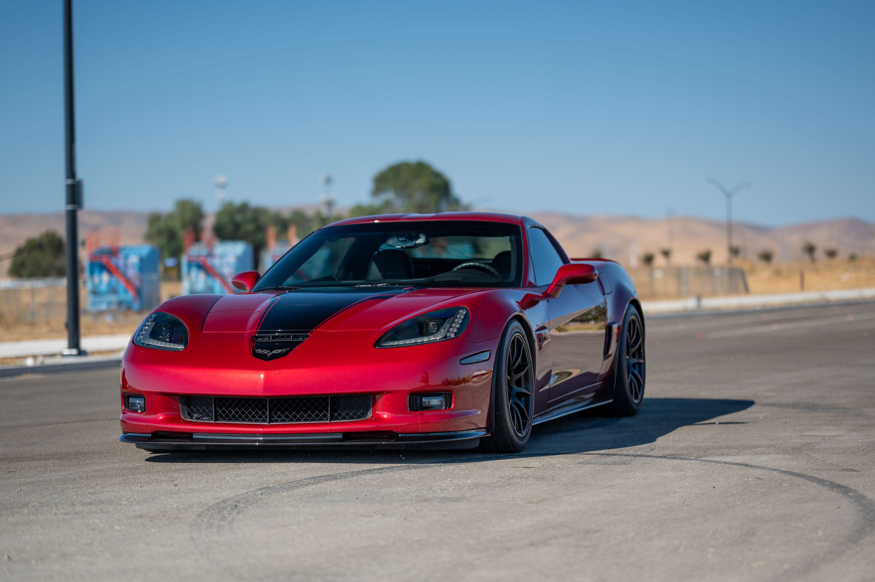 Red Chevrolet C6 Corvette Z06 with 18"/19" SM-10 Apex wheels in Satin Black