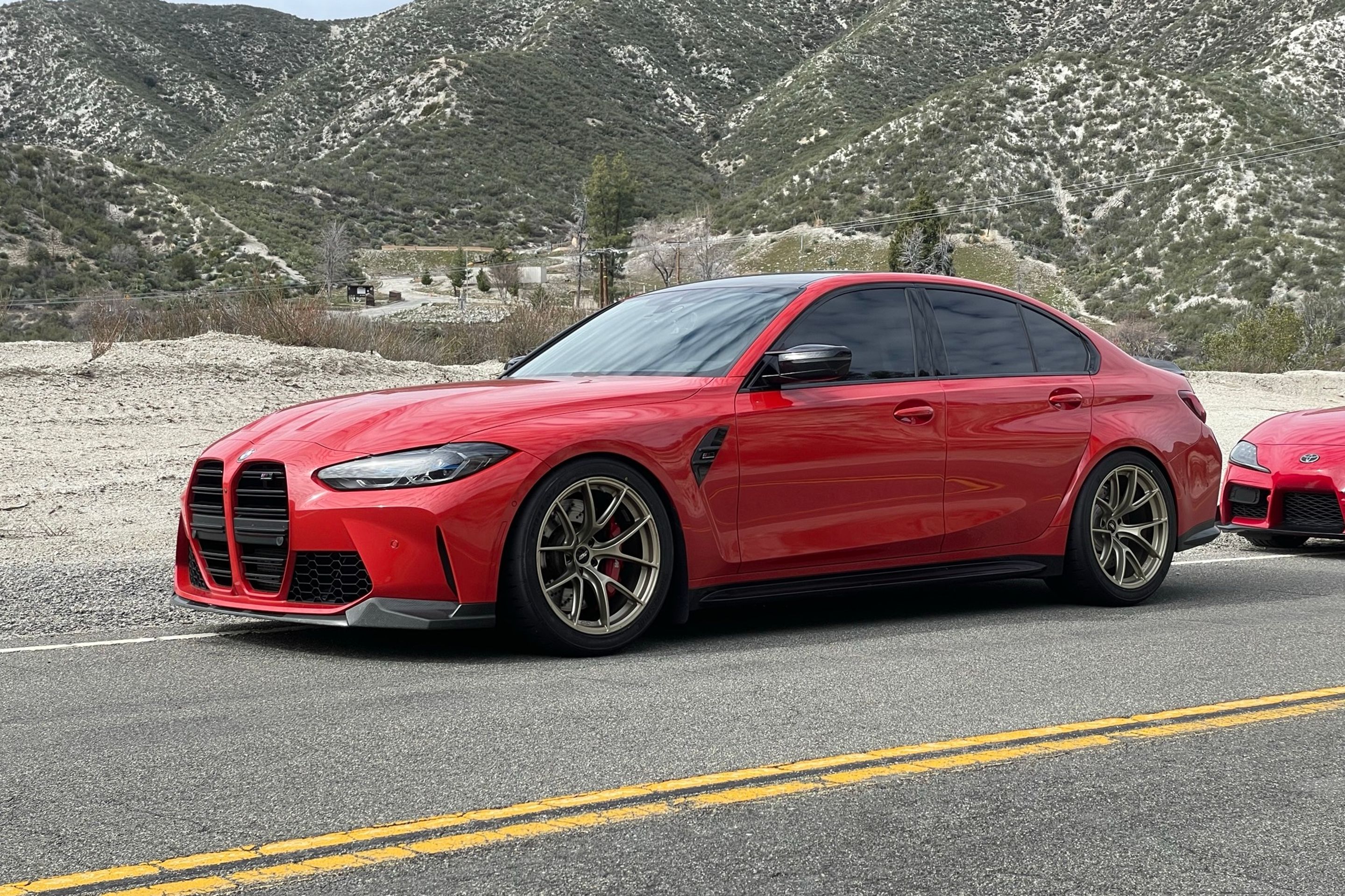 Red BMW G80 M3 with 19" VS-5RS Apex wheels in Motorsport Gold