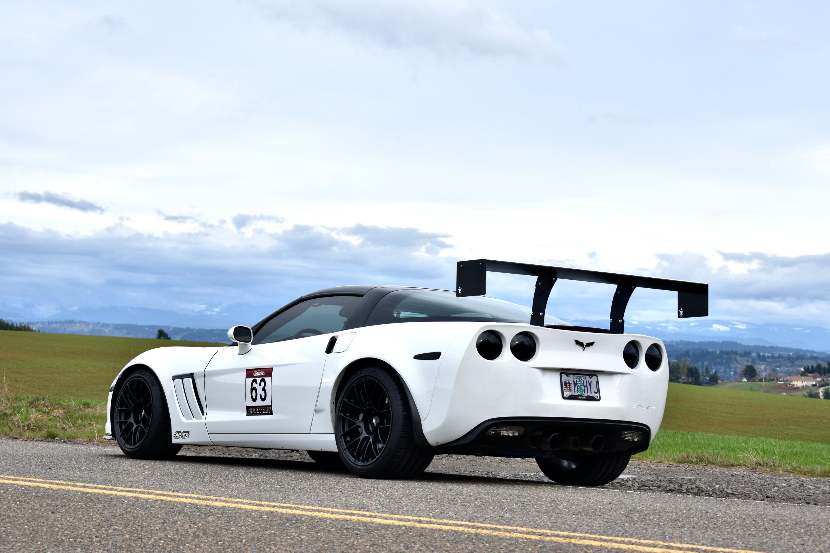 White Chevrolet C6 Corvette Grand Sport with 18"/19" EC-7RS Apex wheels in Satin Black