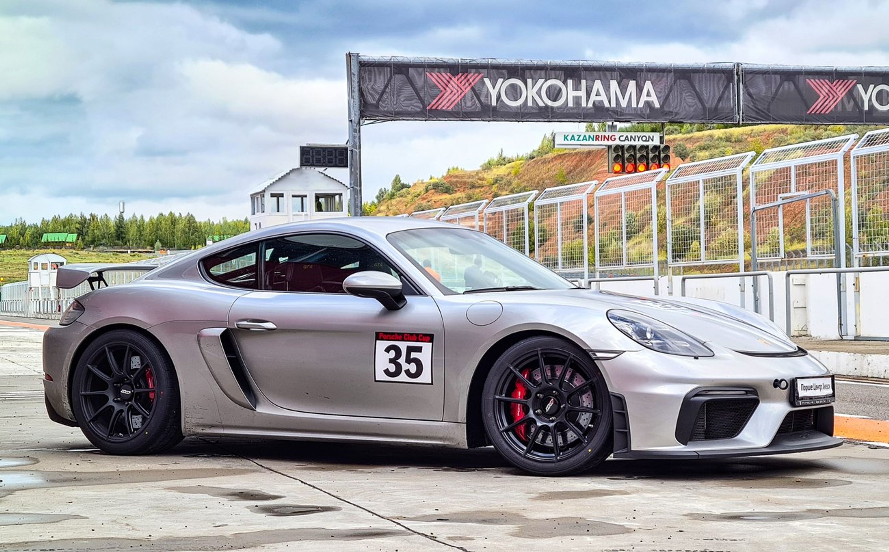 Silver Porsche 718 Cayman GT4 with 19" SM-10 Apex wheels in Satin Black