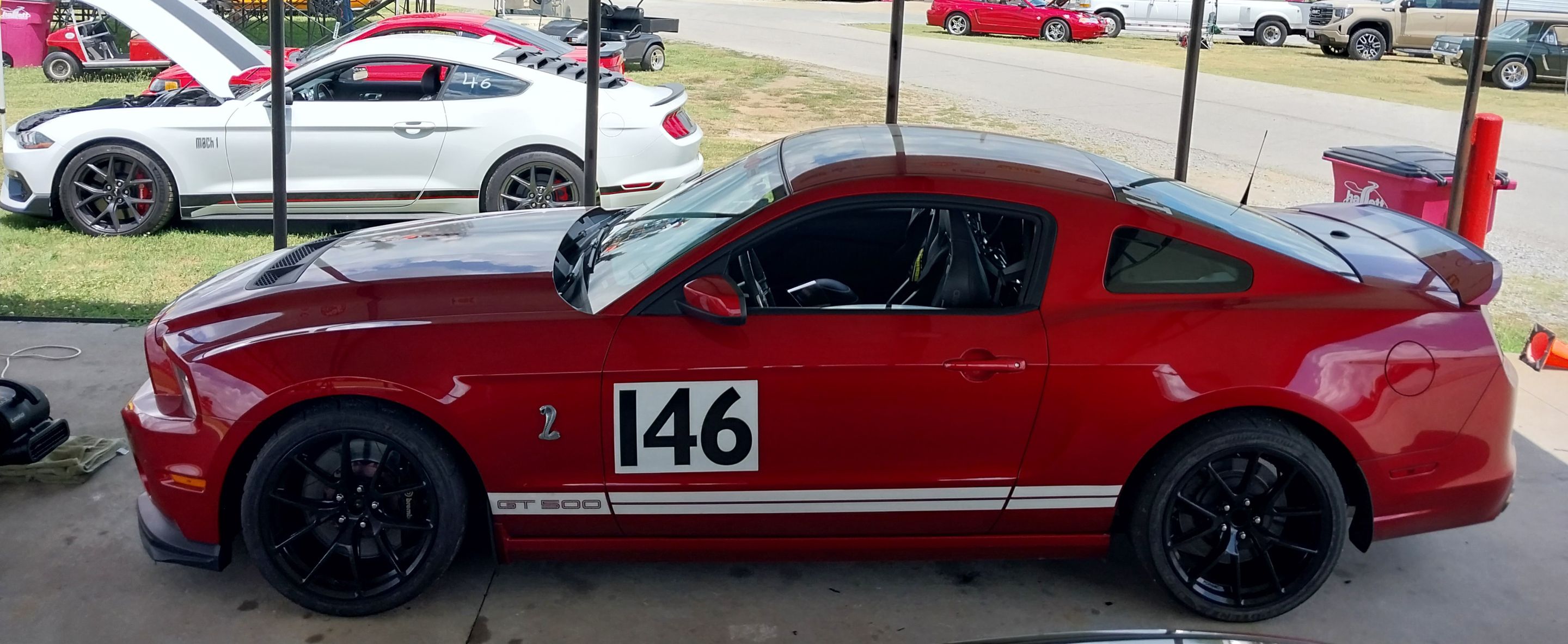 Red Ford S197 Mustang GT500 with 19" VS-5RE Apex wheels in Satin Black