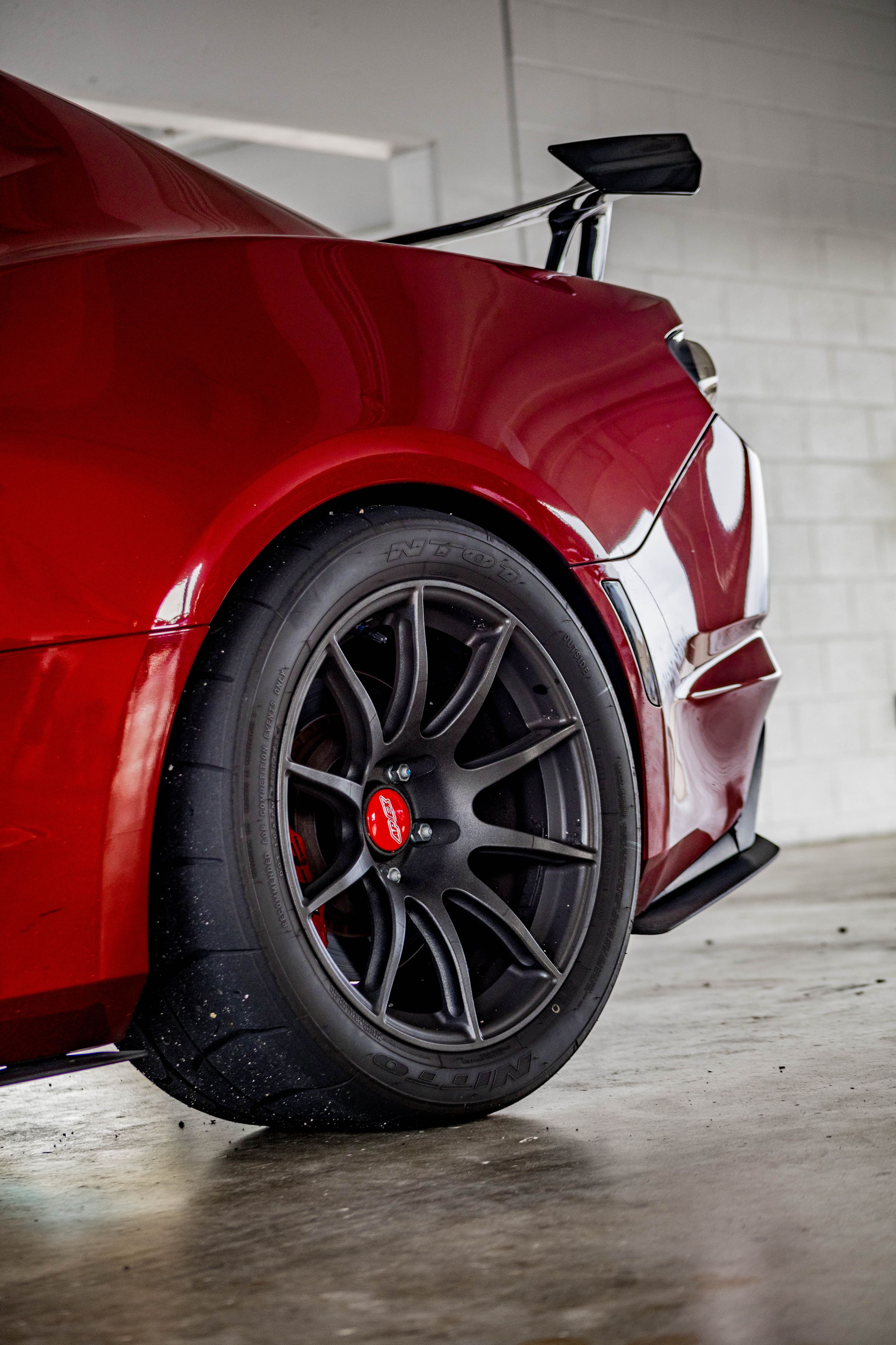 Red Chevrolet 6th Gen Camaro SS with 19" SM-10 Apex wheels in Satin Black