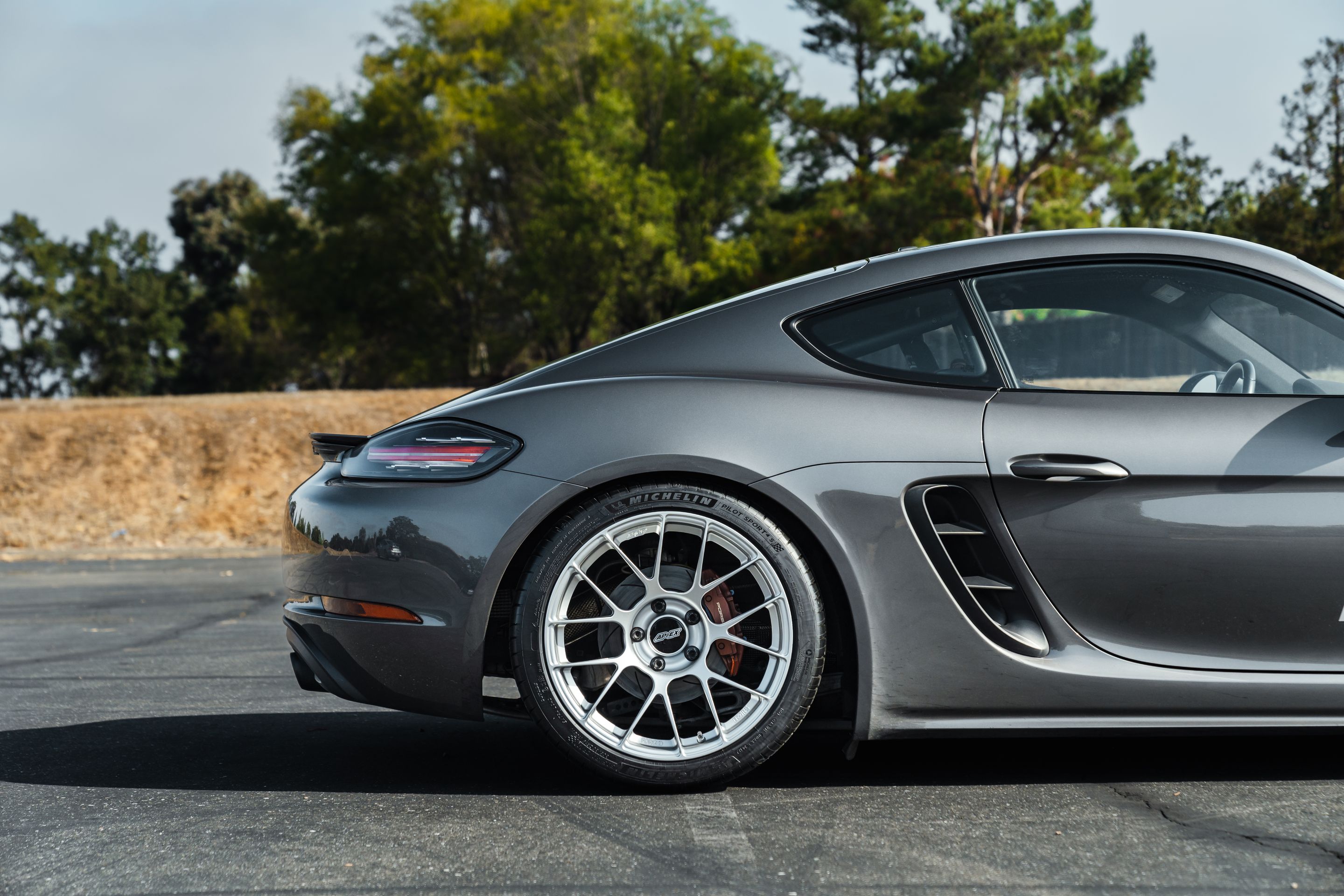 Grey Porsche 718 Cayman S with 19" EC-7RS Apex wheels in Race Silver