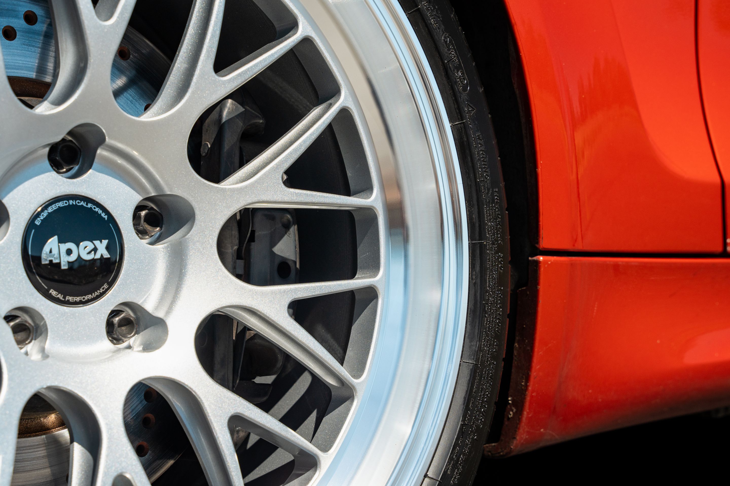 Orange BMW E82 1M with 19" ML-10RT Apex wheels in Machined Lip Race Silver