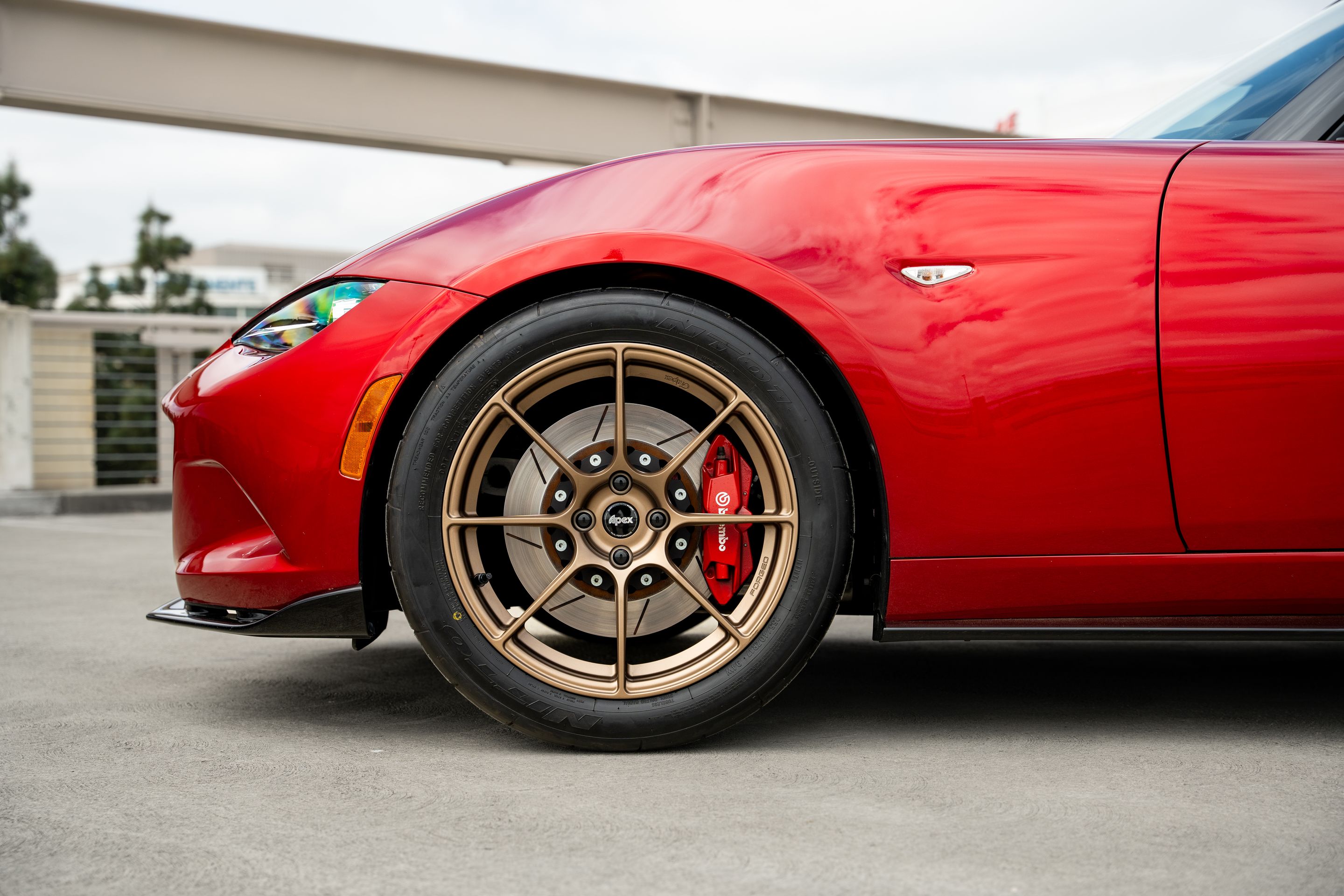 Red Mazda ND MX-5 Miata with 17" SM-8RS Apex wheels in Satin Bronze