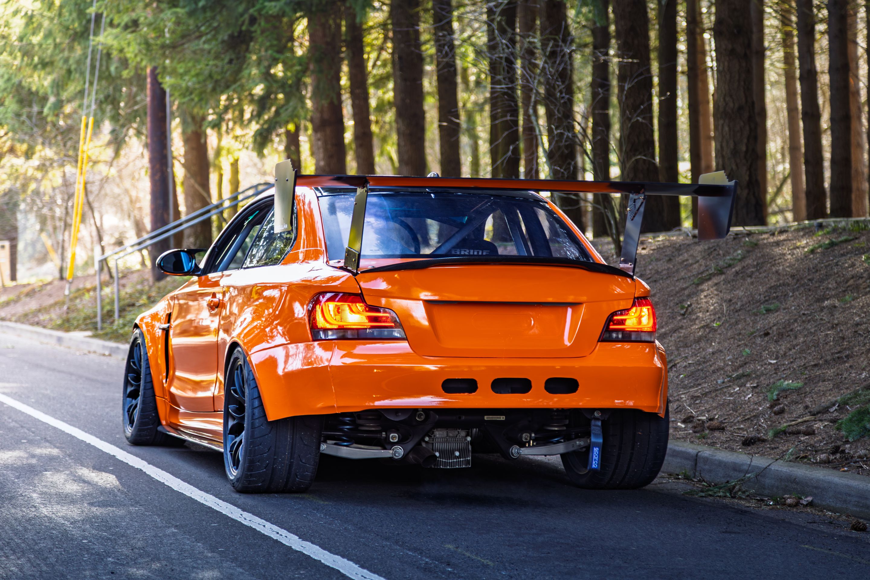 Orange BMW E82 1M with 18" EC-7 Apex wheels in Satin Black