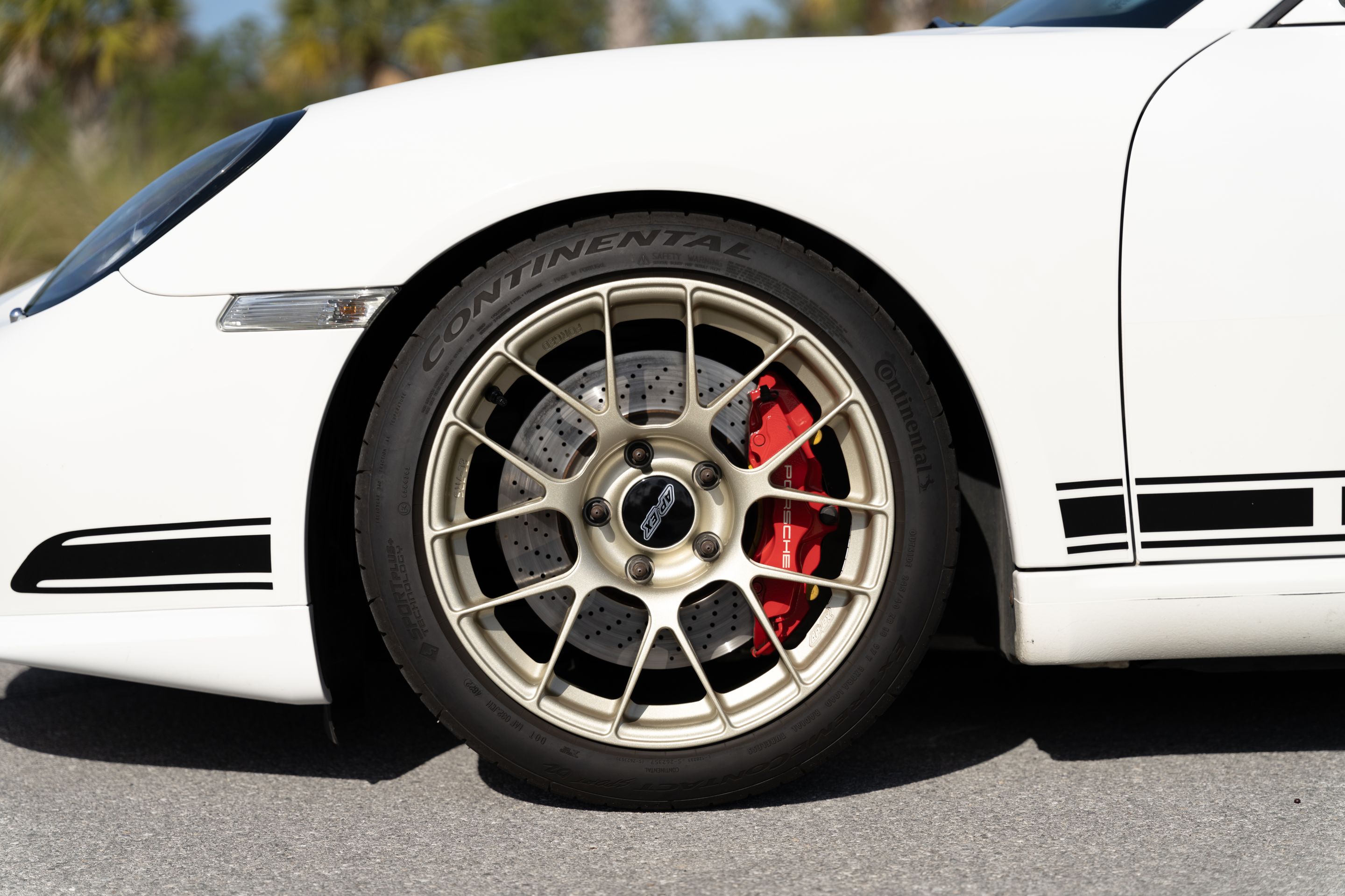 White Porsche 987 Cayman R with 18" EC-7RS Apex wheels in Motorsport Gold