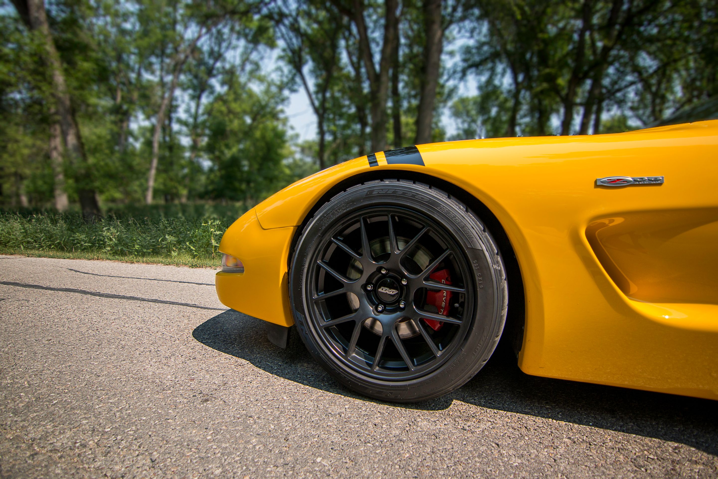 Yellow Chevrolet C5 Corvette Z06 with 18" EC-7 Apex wheels in Satin Black