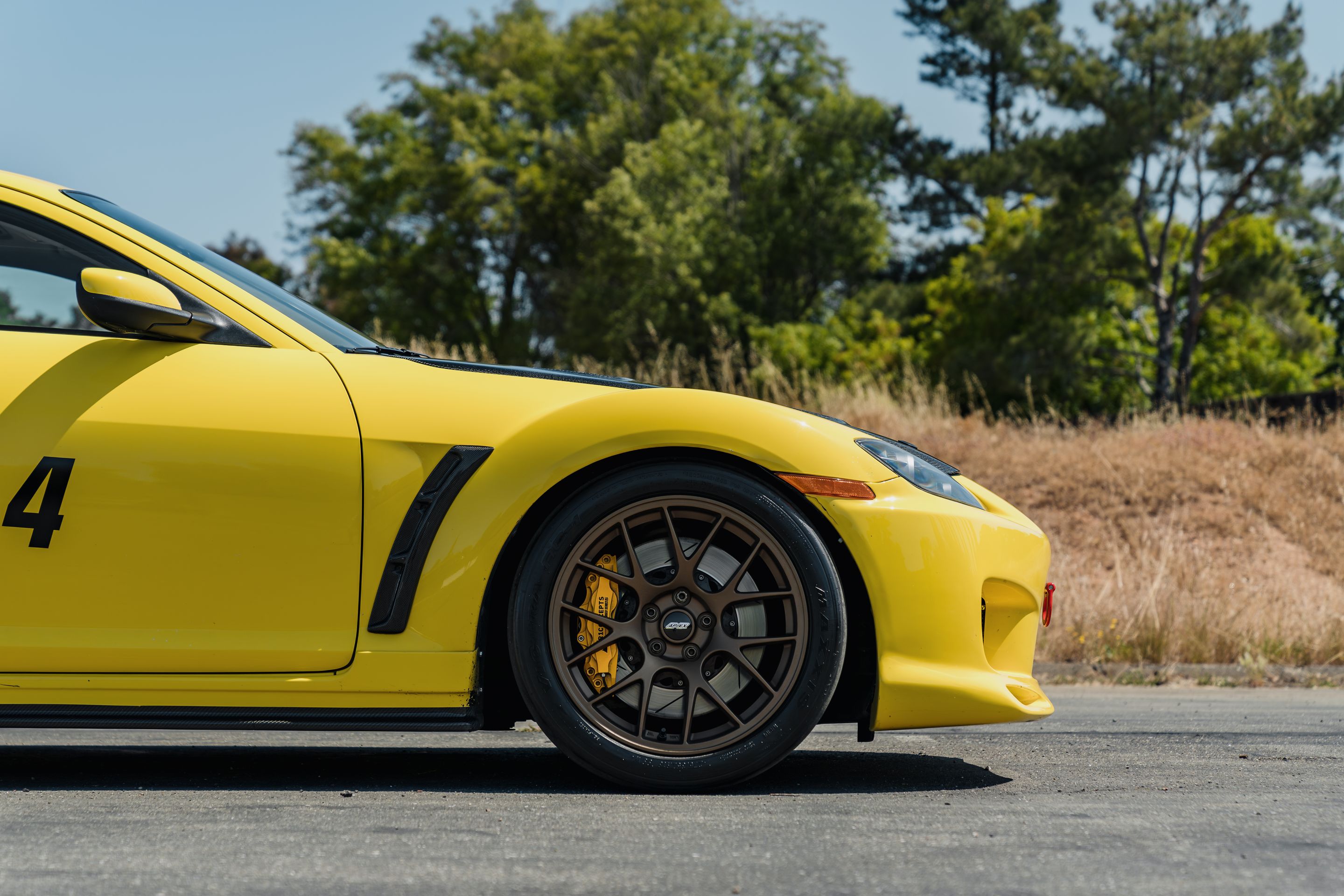 Yellow Mazda RX-8 with 18" EC-7 Apex wheels in Satin Bronze