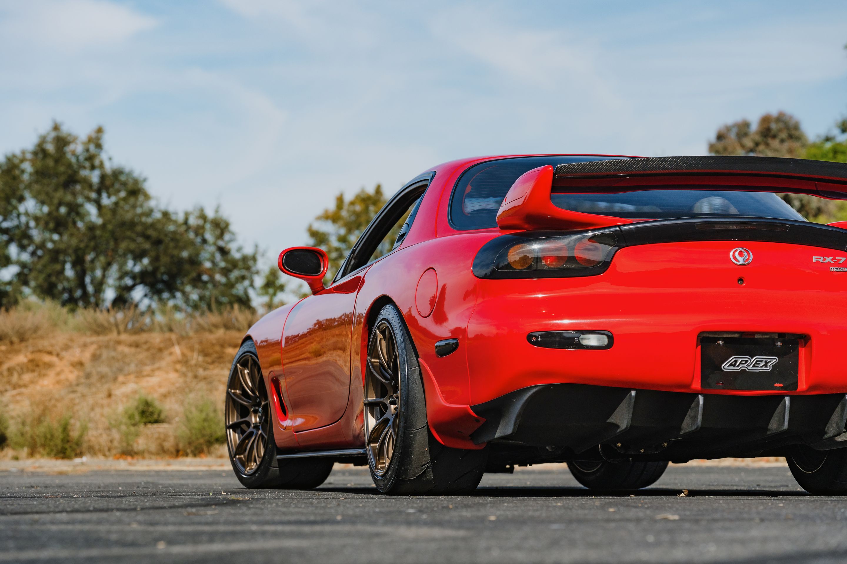 Red Mazda FD RX-7 with 18" SM-10RS Apex wheels in Satin Bronze