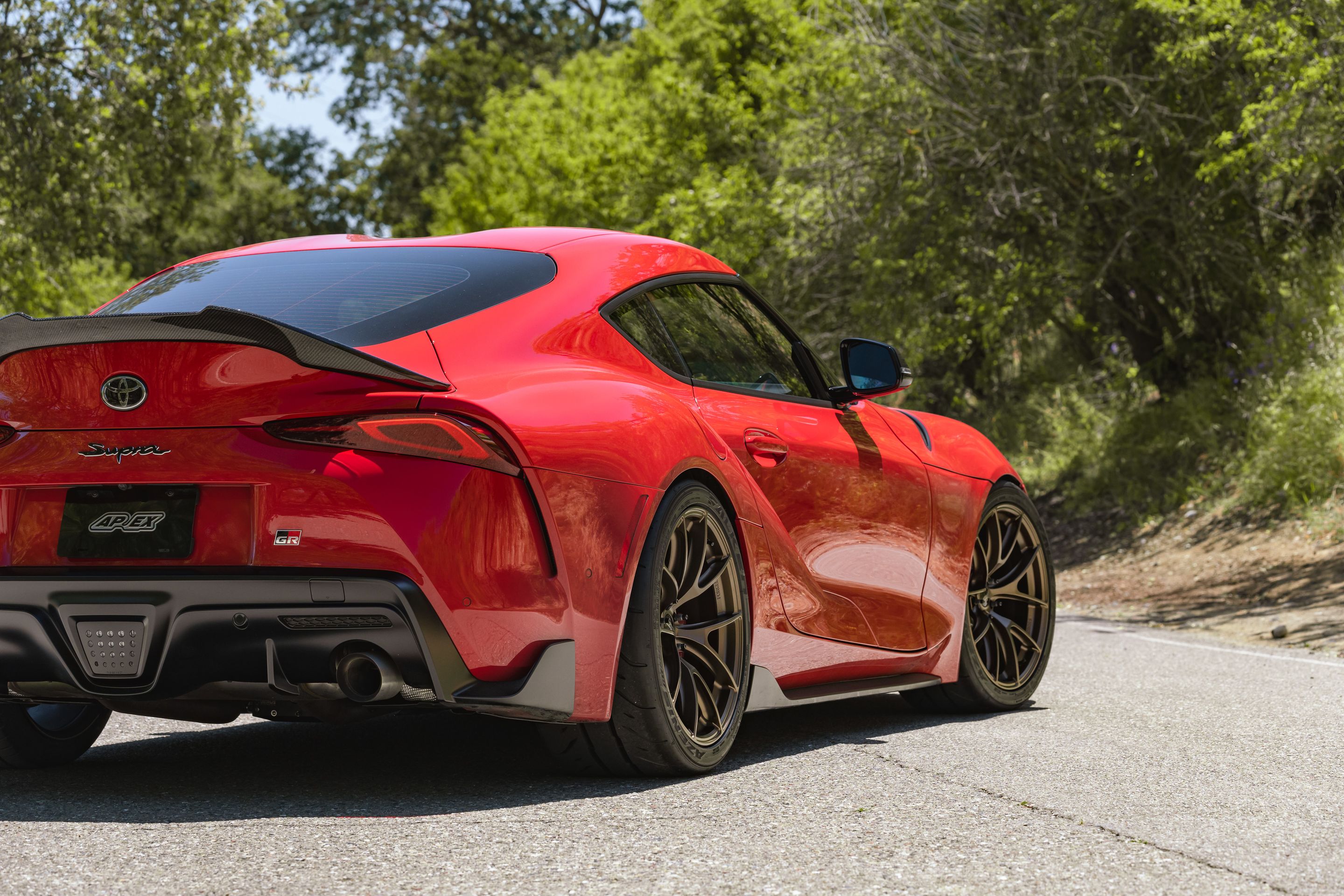 Red Toyota GR Supra with 19" VS-5RS Apex wheels in Satin Bronze