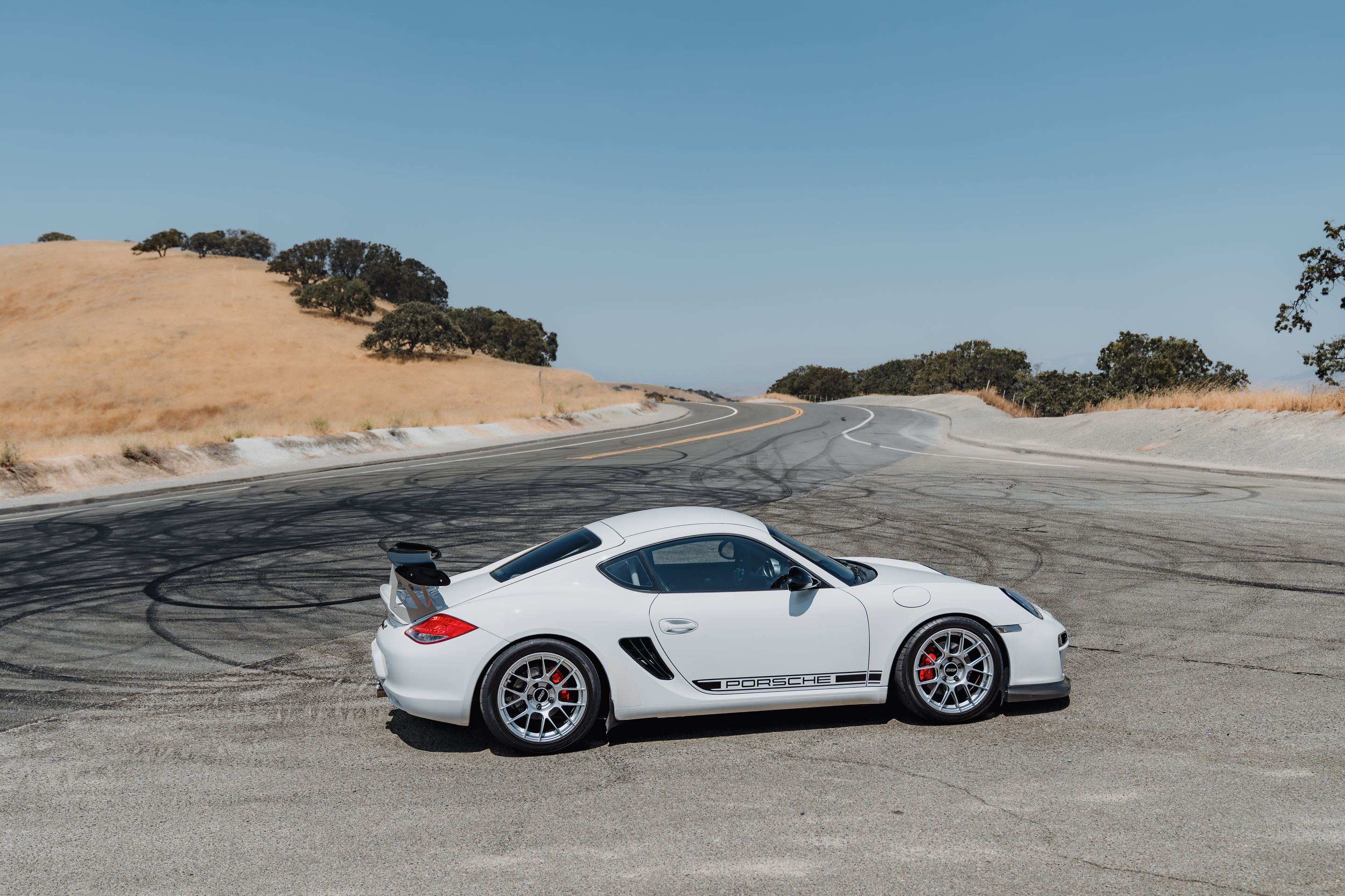 White Porsche 987 Cayman R with 18" EC-7RS Apex wheels in Race Silver
