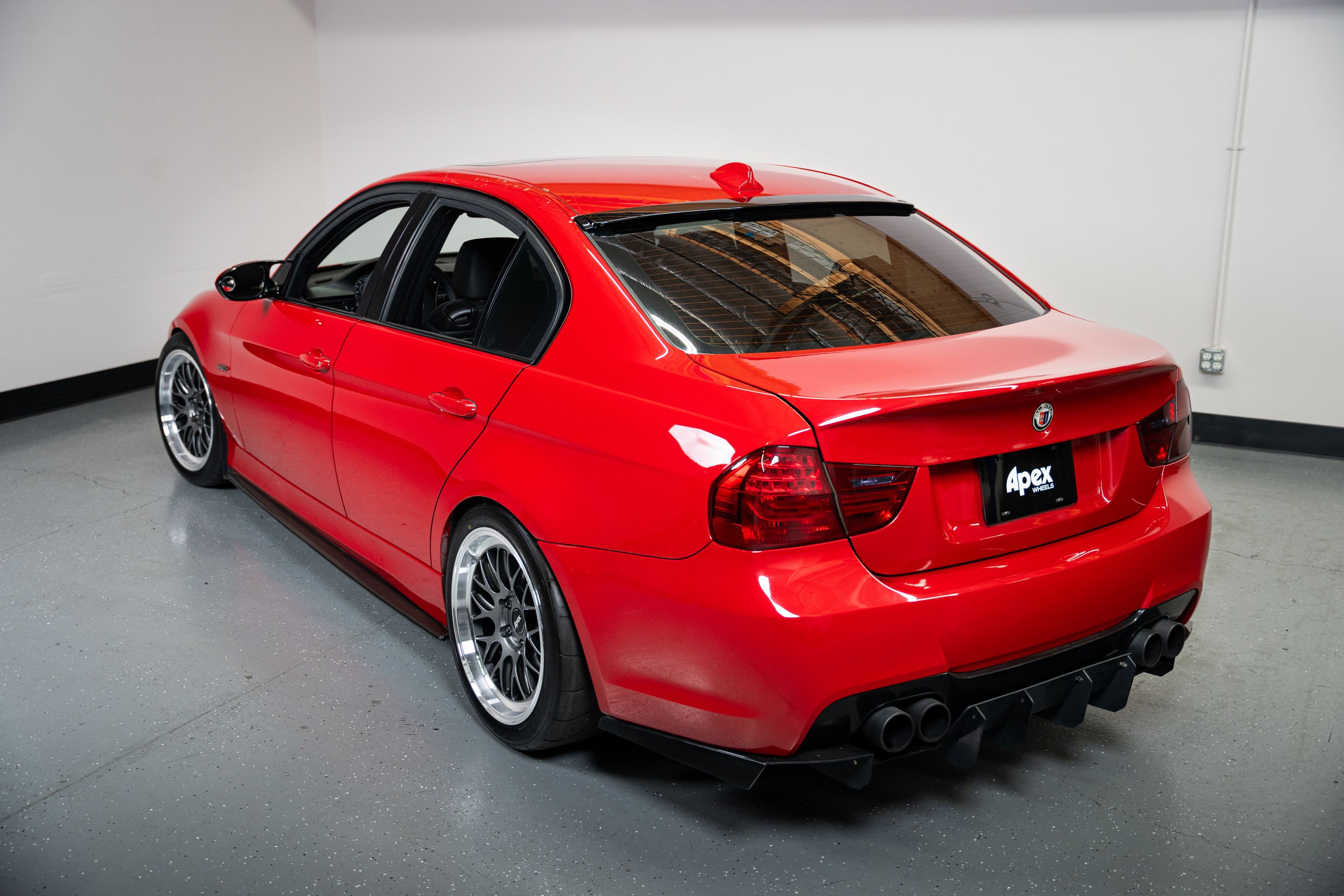 Red BMW E90 Sedan 3 Series with 18" ML-10RT Apex wheels in Machined Lip Anthracite