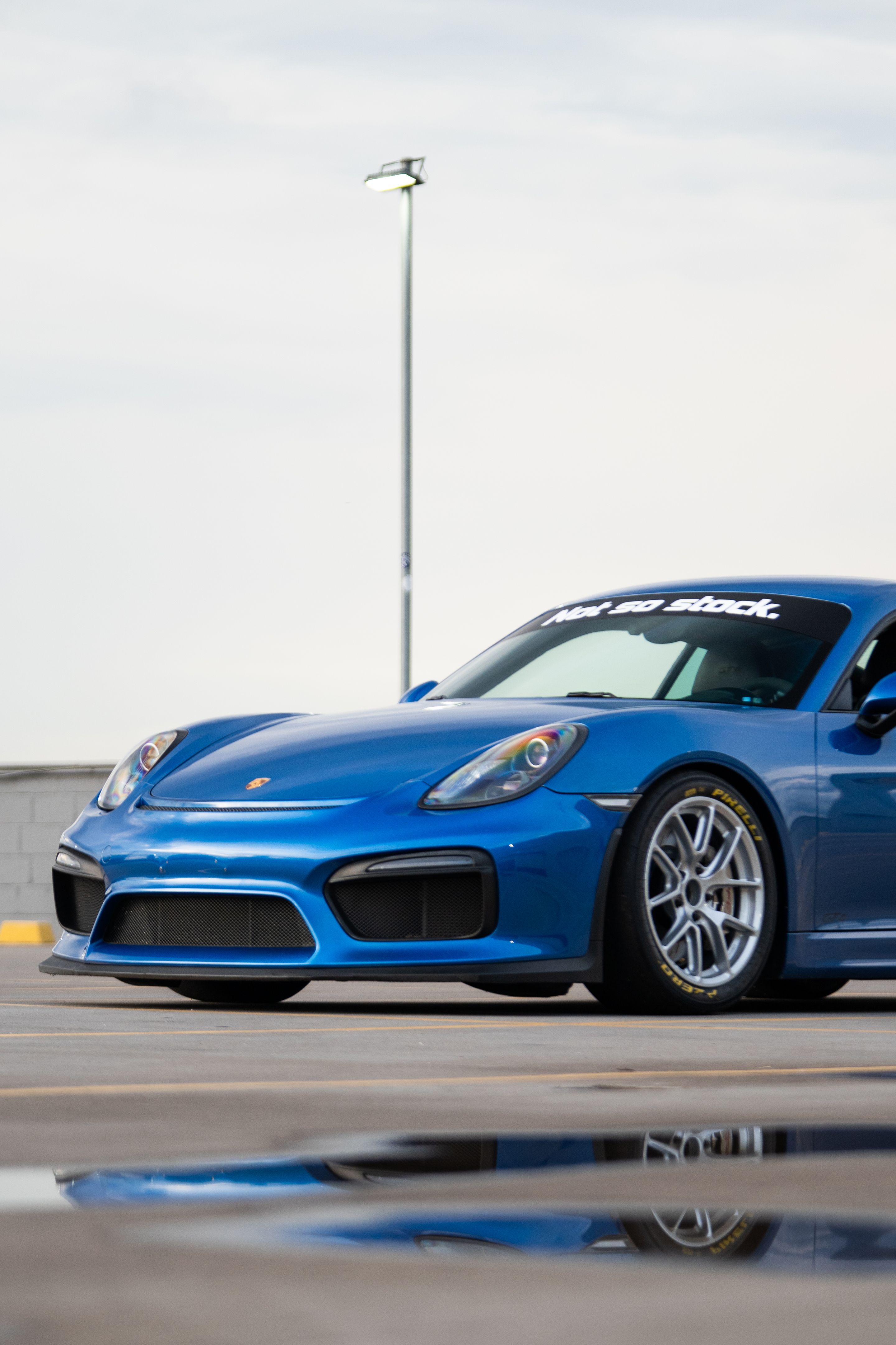 Blue Porsche 981 Cayman GT4 with 18" VS-5RE Apex wheels in Race Silver