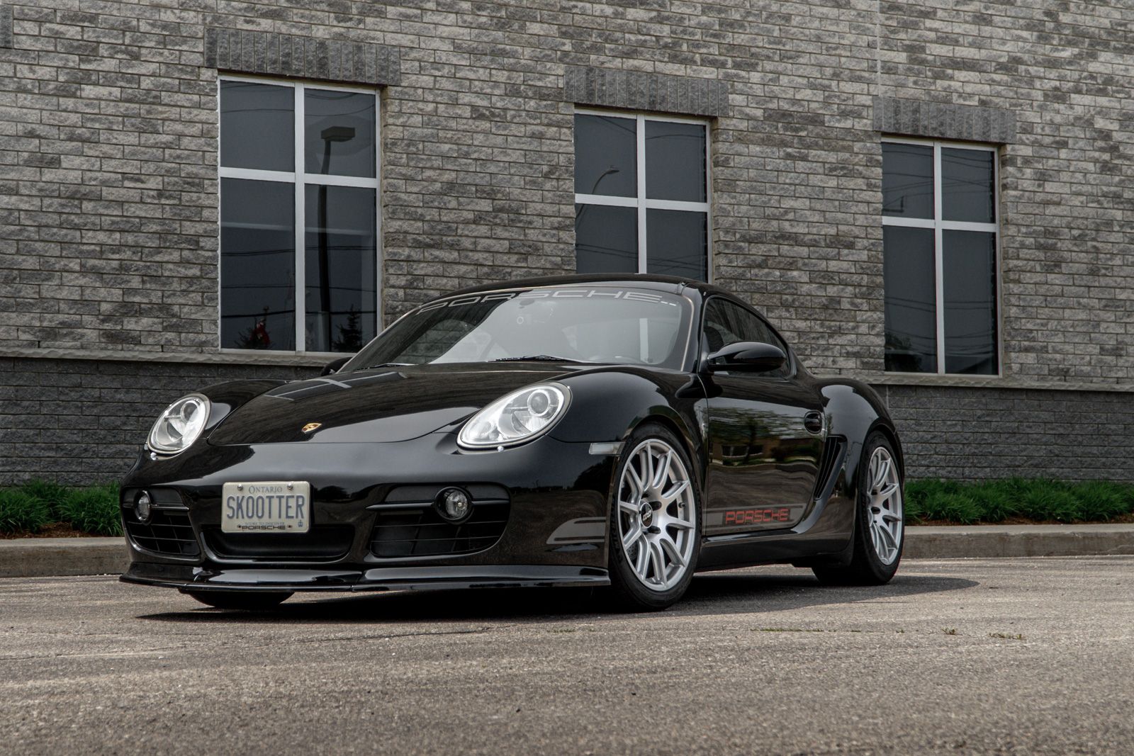 Black Porsche 987 Cayman Base with 18" SM-10 Apex wheels in Race Silver