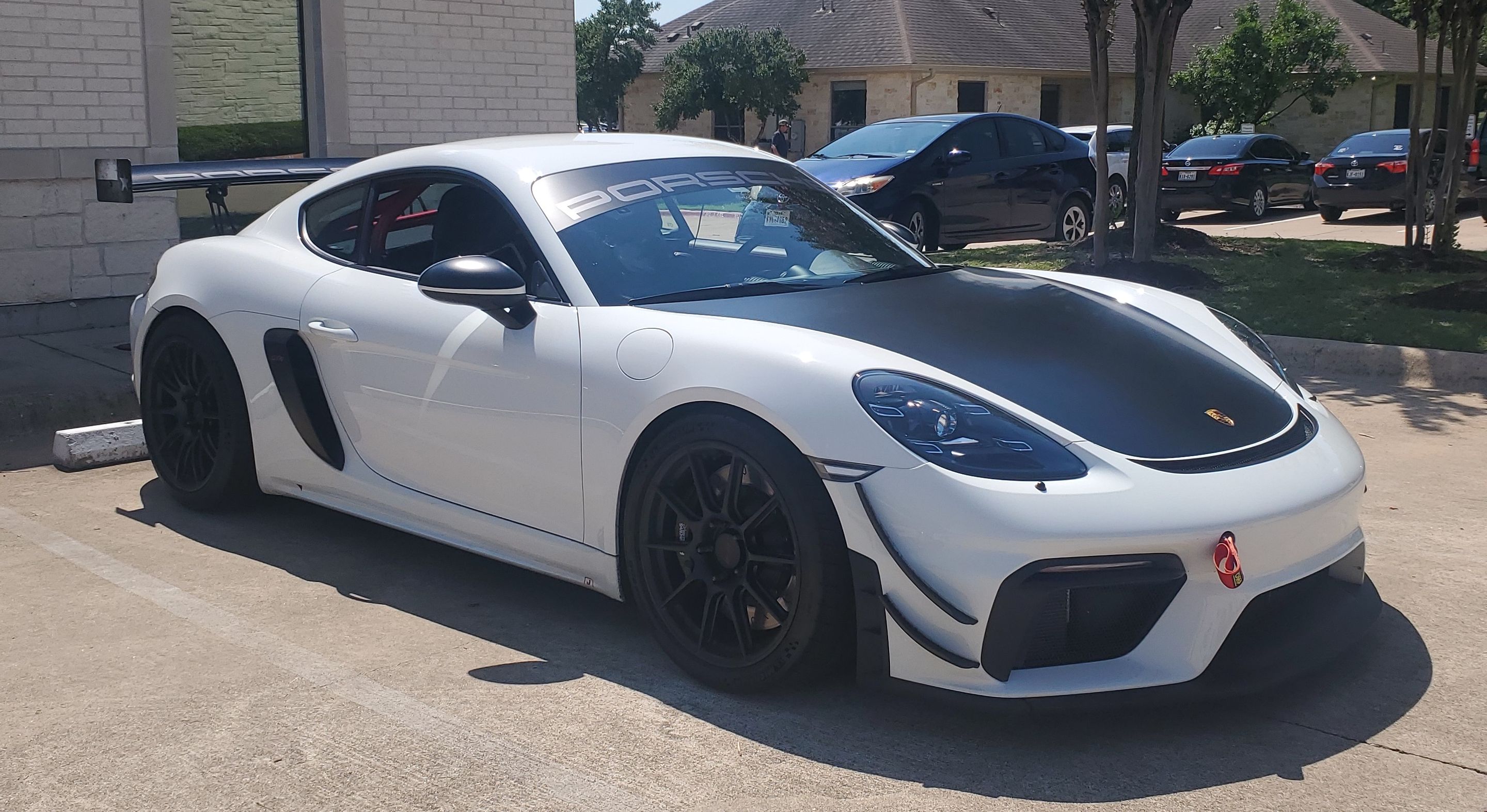 White Porsche 718 Cayman GT4 with 19" SM-10 Apex wheels in Satin Black