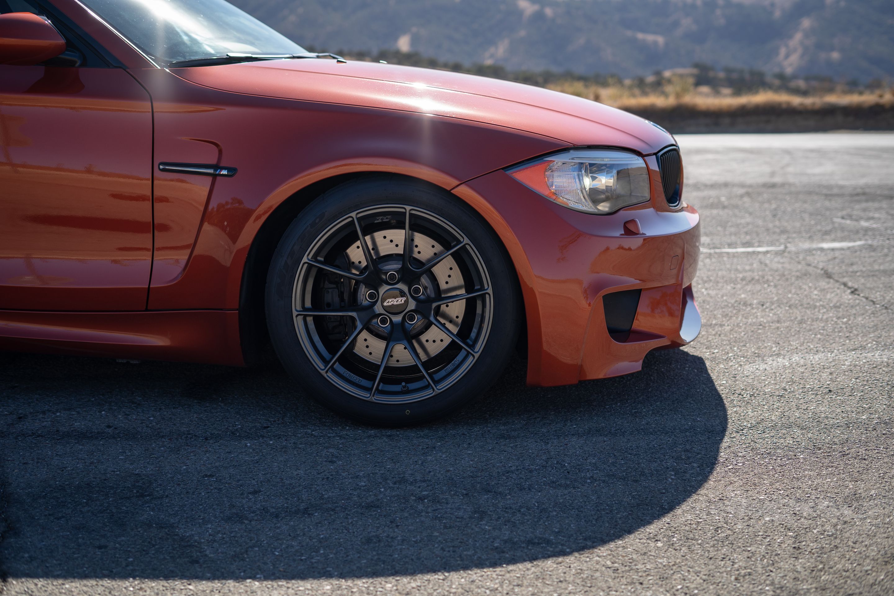 Orange BMW E82 1M with 18" VS-5RS Apex wheels in Anthracite