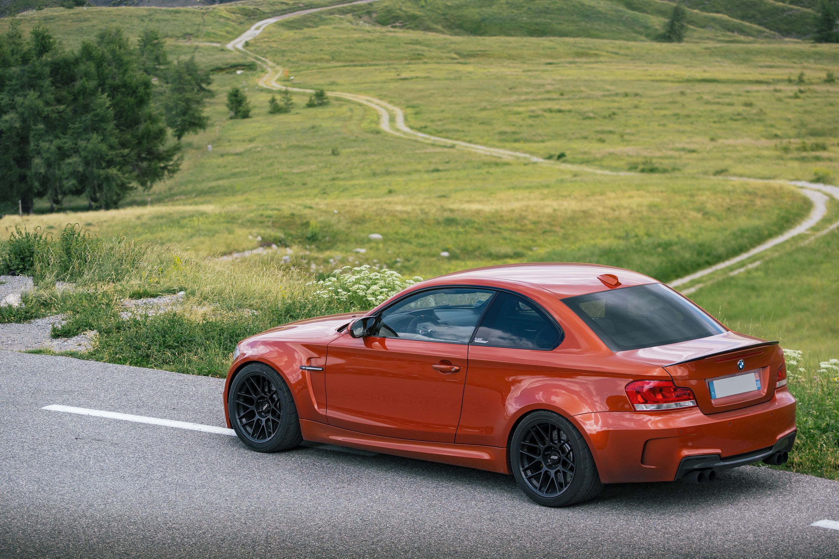 Orange BMW E82 1M with 18" ARC-8 Apex wheels in Satin Black