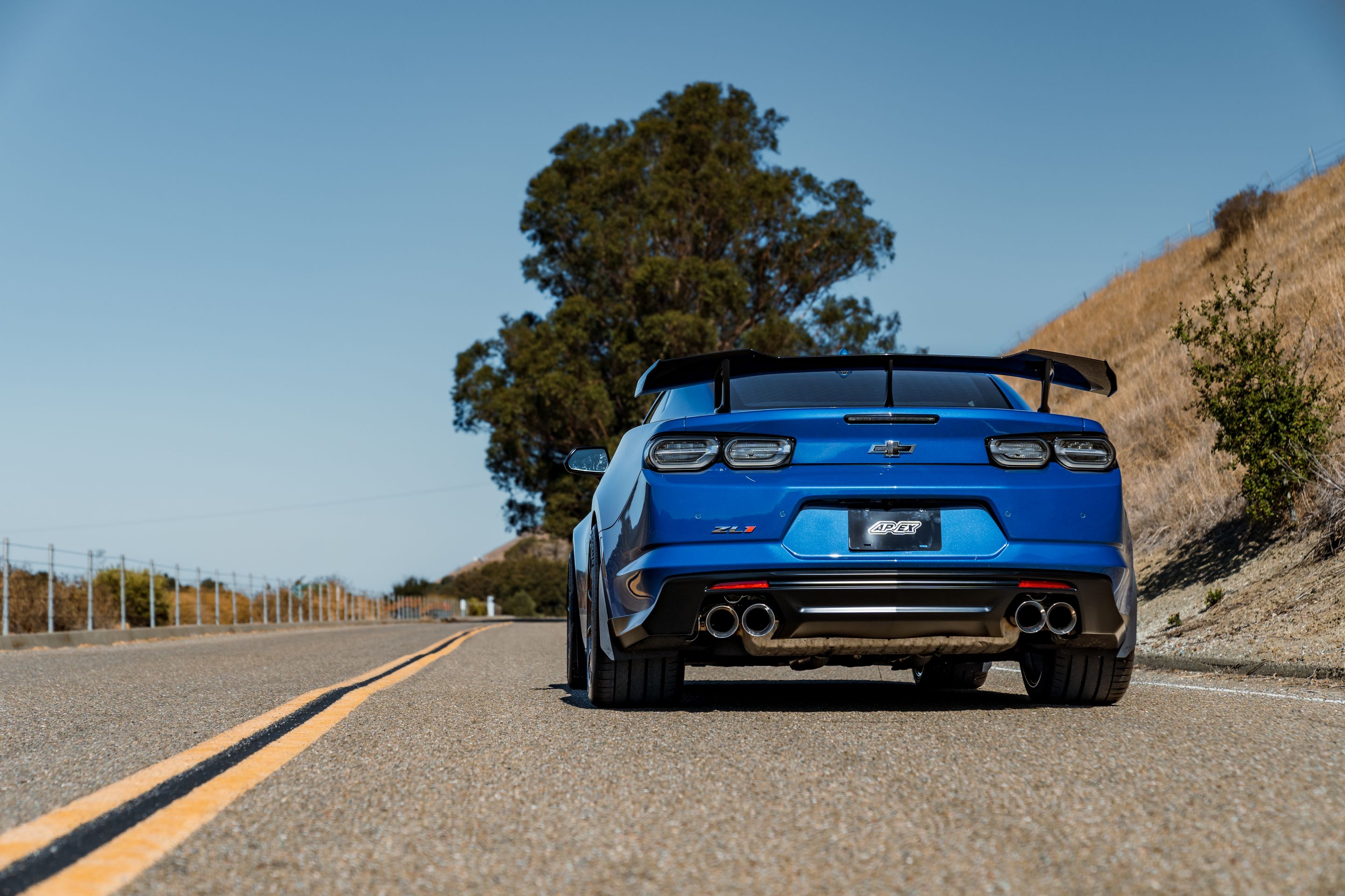 Blue Chevrolet 6th Gen Camaro ZL1 1LE with 19" SM-10RS Apex wheels in Satin Bronze