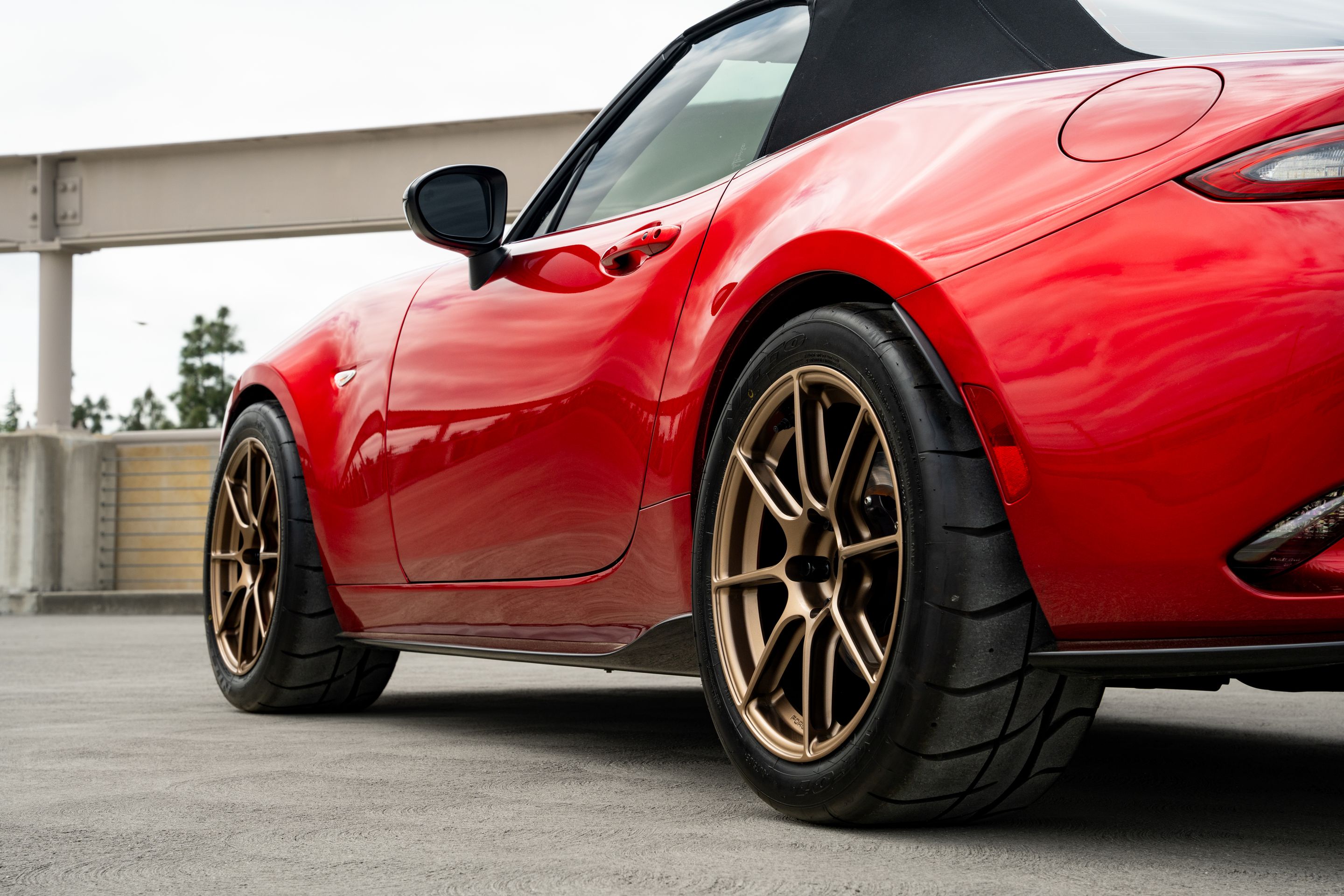 Red Mazda ND MX-5 Miata with 17" SM-8RS Apex wheels in Satin Bronze