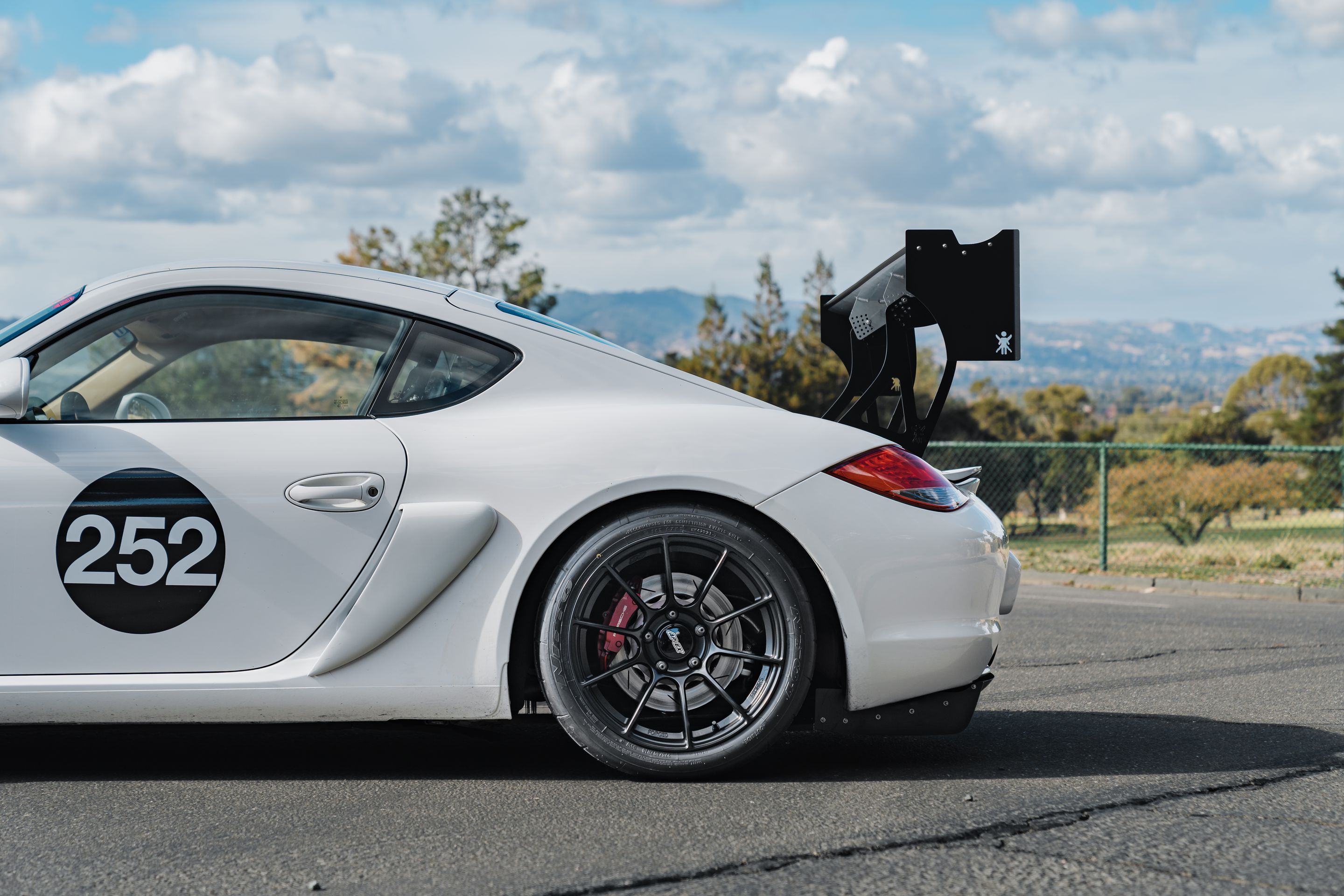 White Porsche 987 Cayman S with 18" SM-10RS Apex wheels in Satin Black
