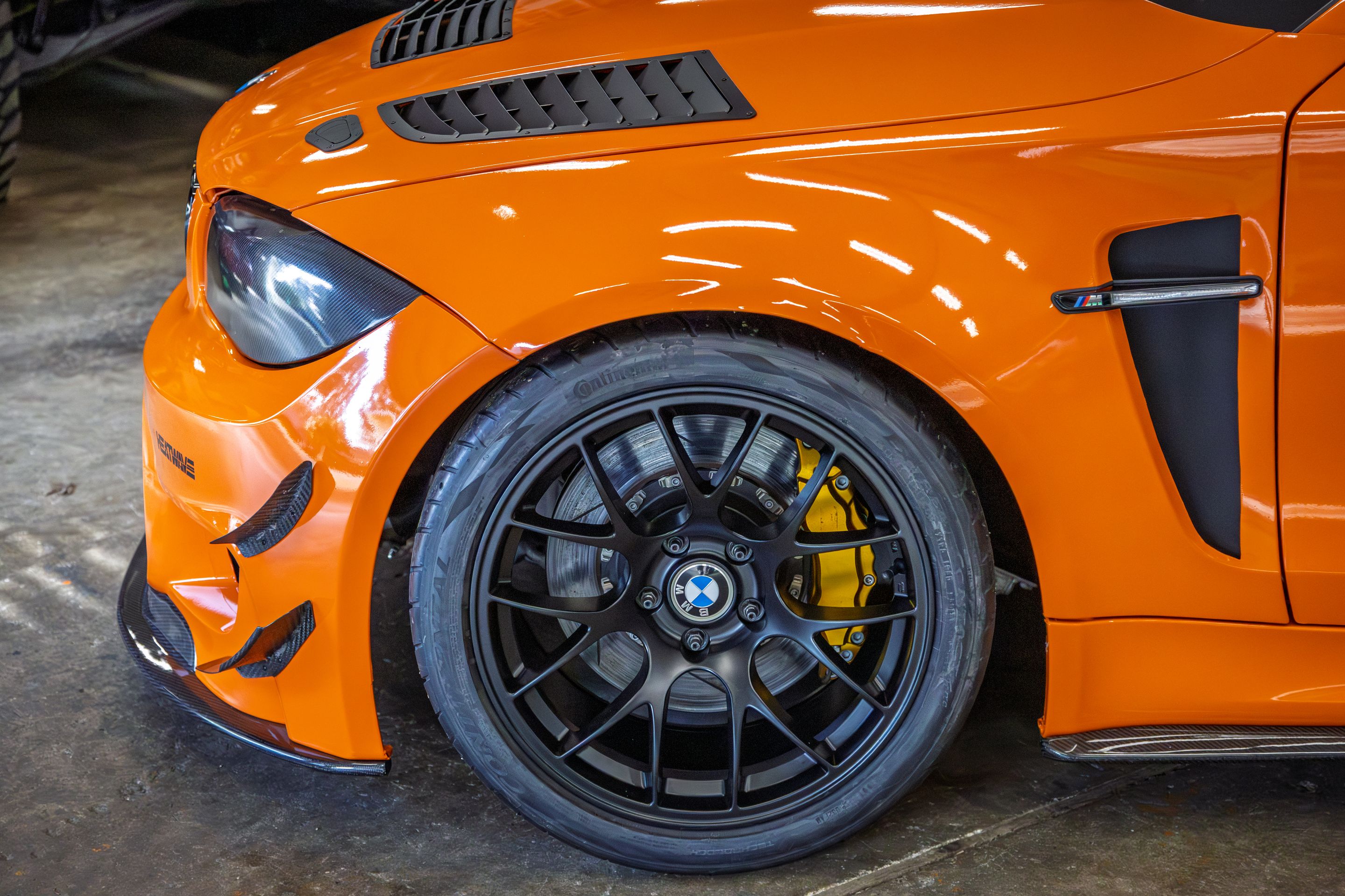Orange BMW E82 1M with 18" EC-7 Apex wheels in Satin Black