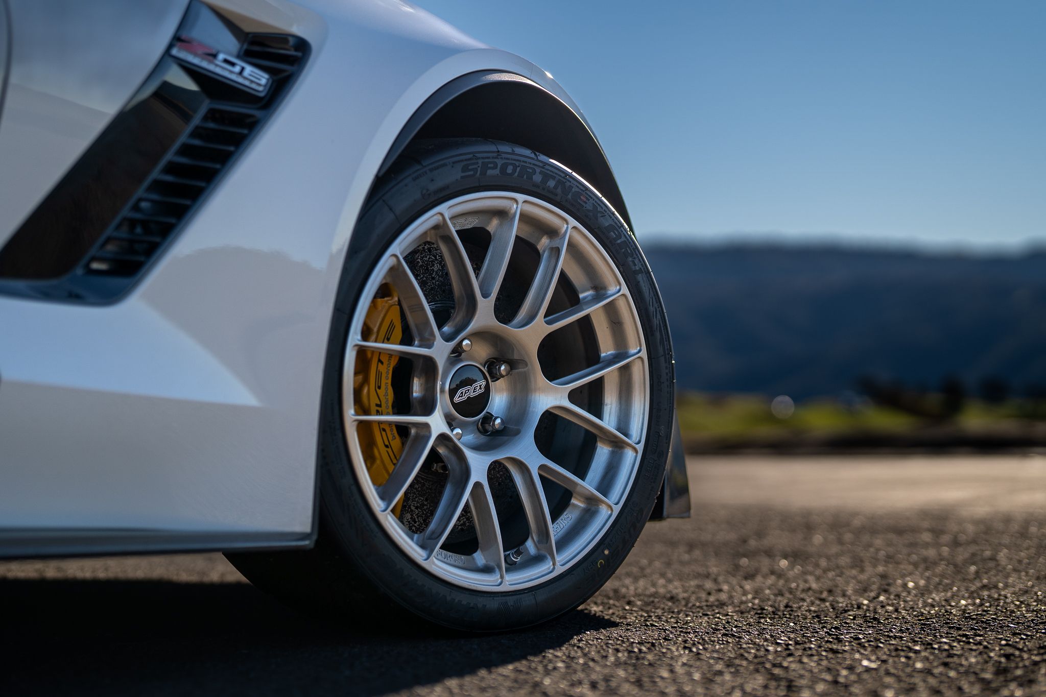 White Chevrolet C7 Corvette Z06 with 18" EC-7RS Apex wheels in Brushed Clear