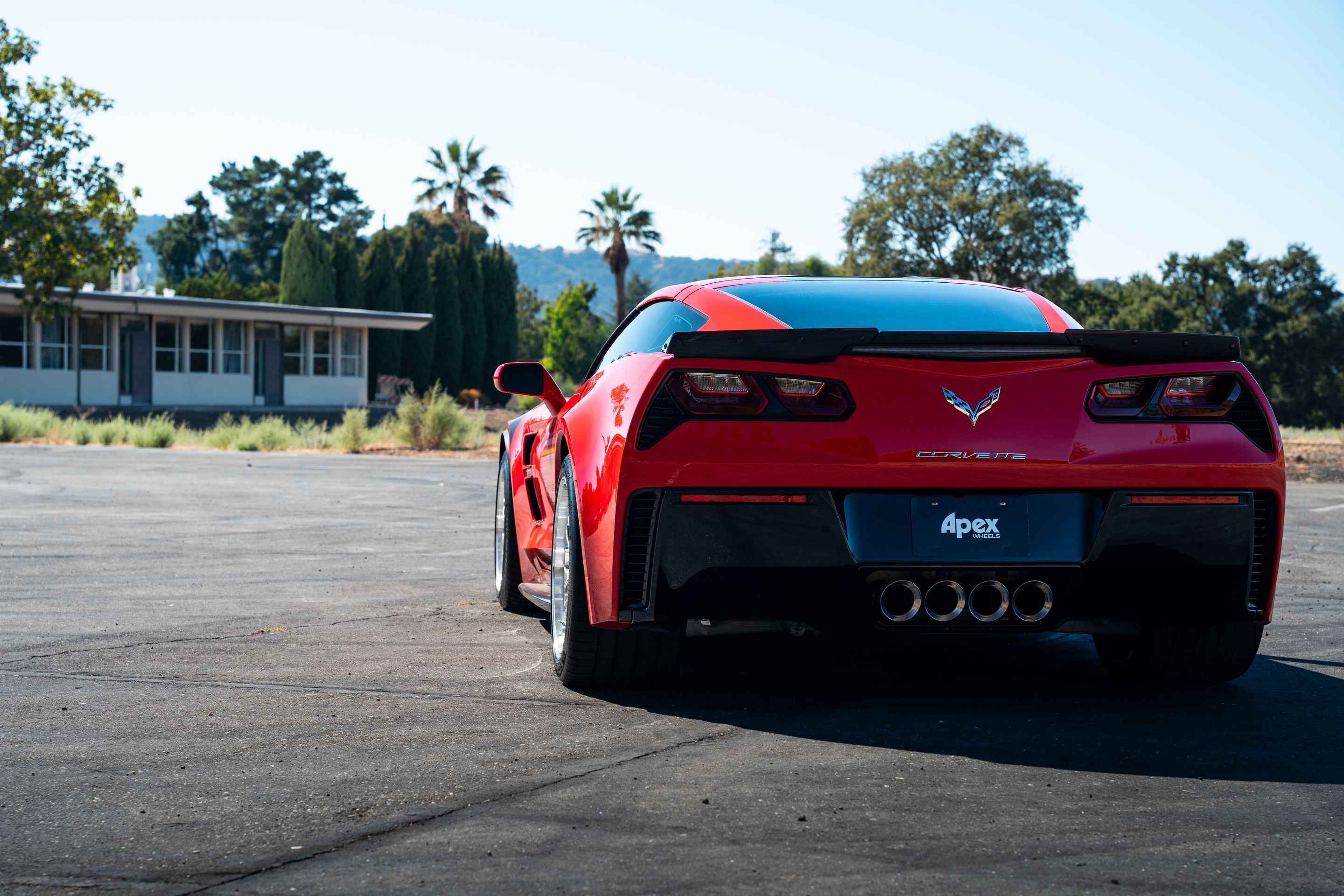 Red Chevrolet C7 Corvette Grand Sport with 18"/19" ML-10RT Apex wheels in Machined Lip Race Silver