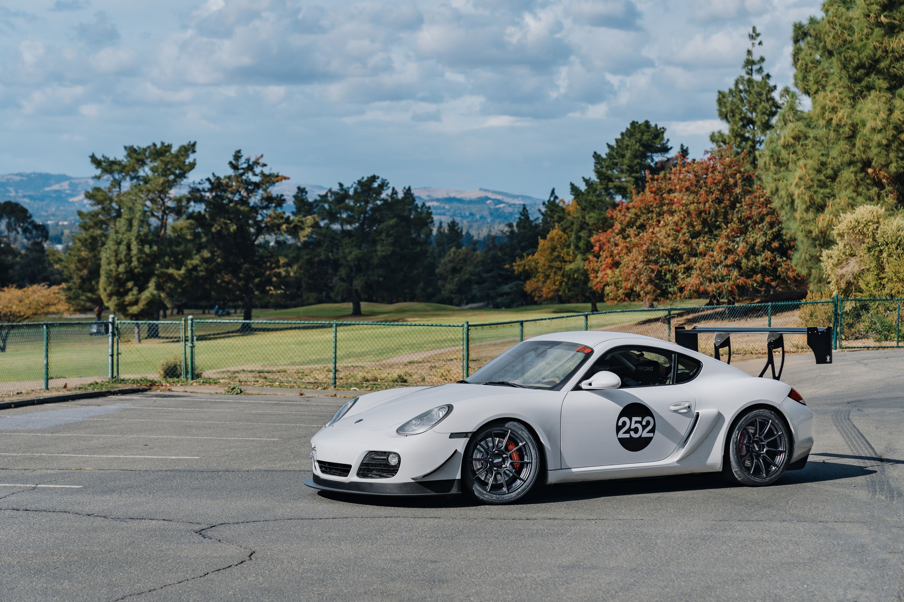 White Porsche 987 Cayman S with 18" SM-10RS Apex wheels in Satin Black