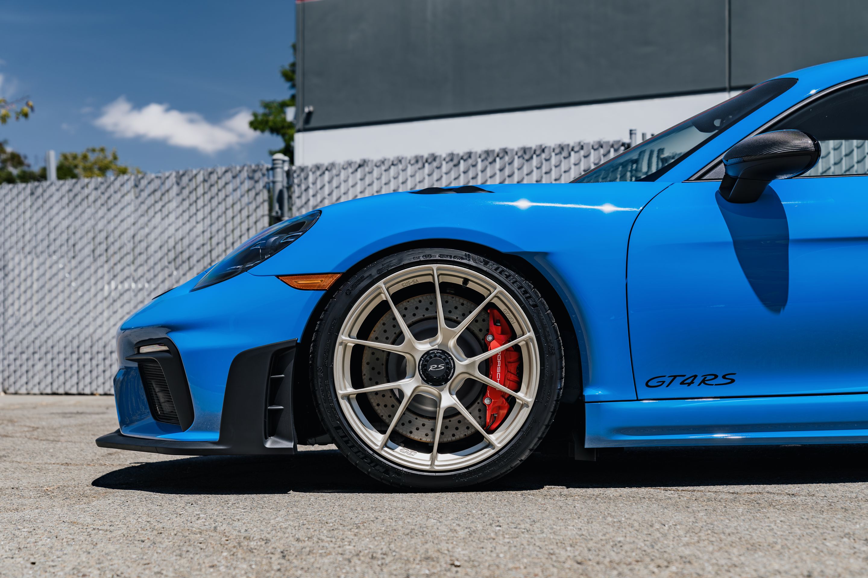 Blue Porsche 718 Cayman GT4 RS with 20" VS-5RS Apex wheels in Motorsport Gold