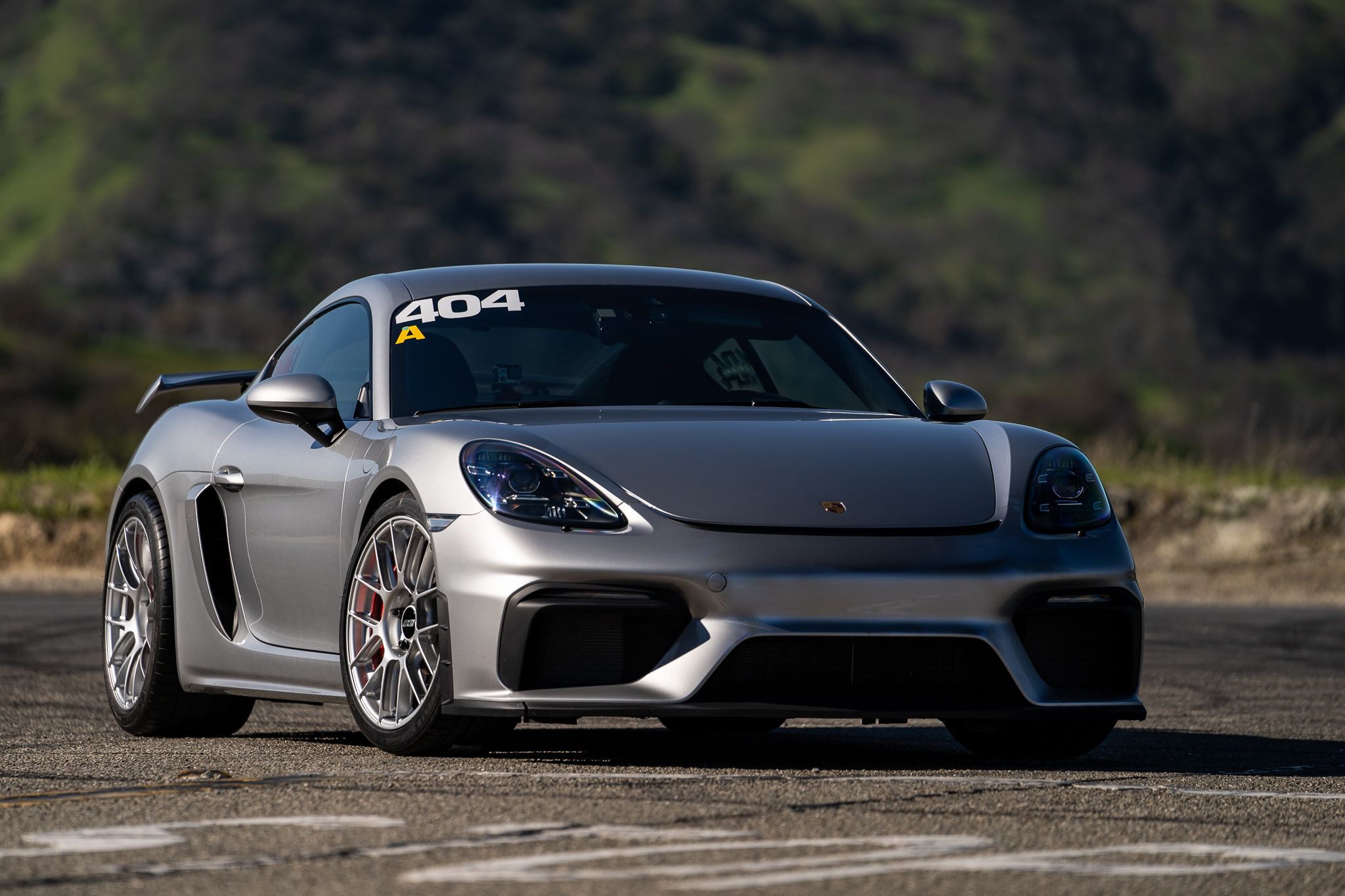 Grey Porsche 718 Cayman GT4 with 19" EC-7RS Apex wheels in Race Silver